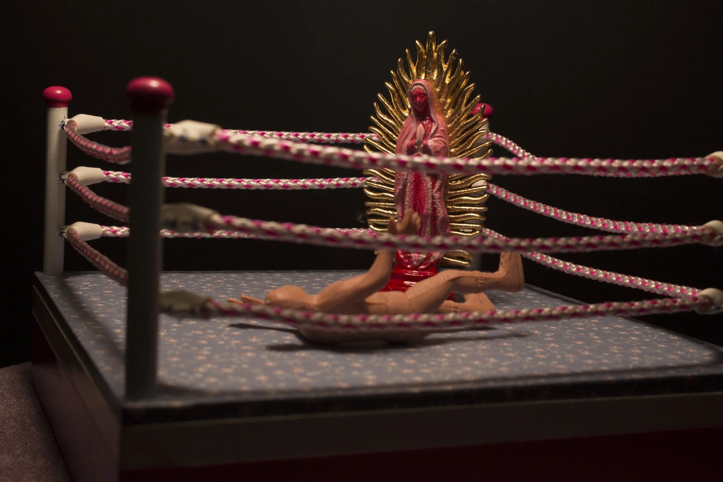 lunchando contra el machismo (wrestling against macho-ness) , 2015 religious & toy figures, rope, floral wall paper, vinyl, duck tape, lace, velvet, floral lamp, wood 56'' x 26" x 26" photo credit: Jill Grant 