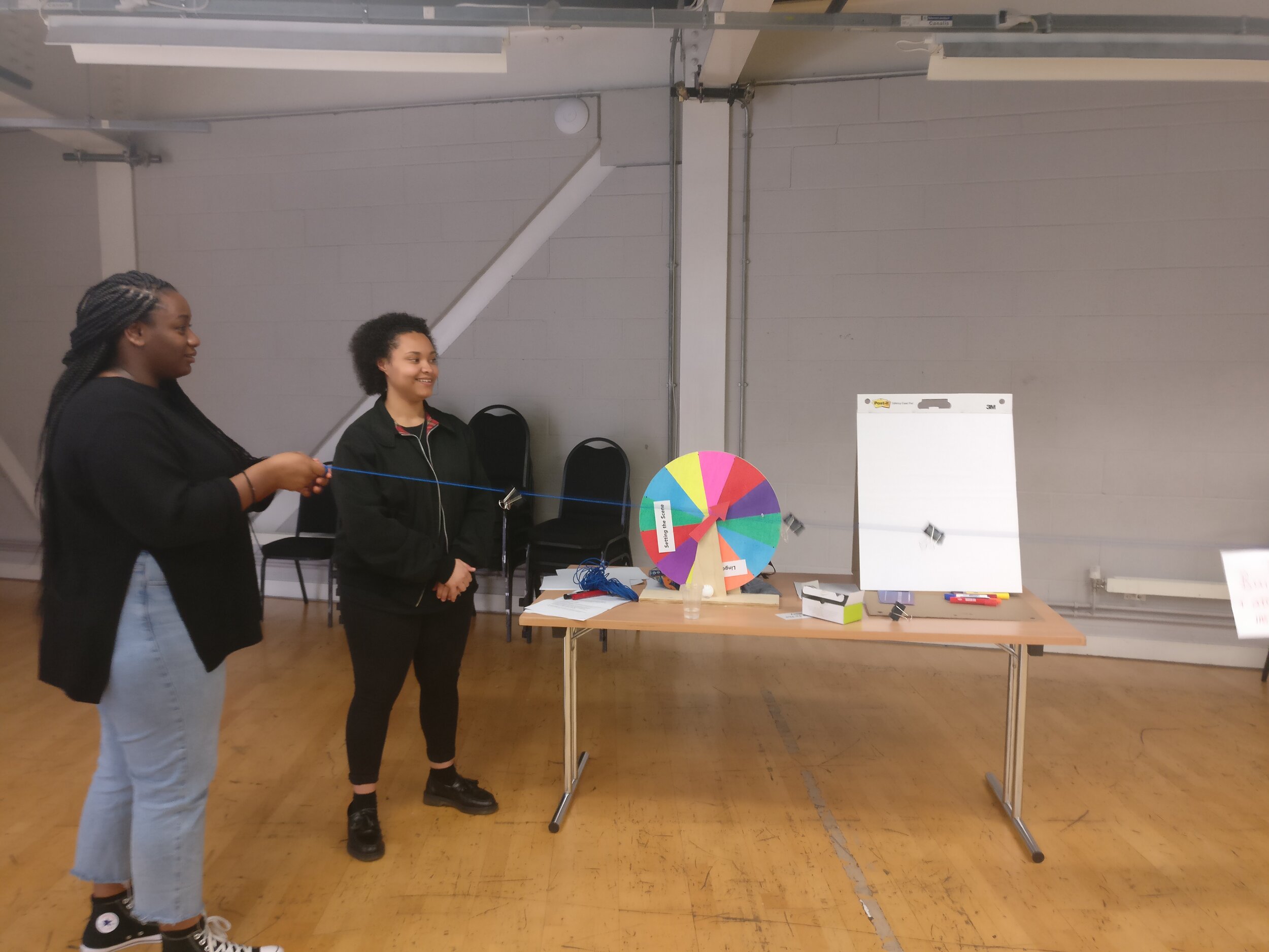 Spin the wheel in the back with PEER Ambassadors Devinya and Ellise