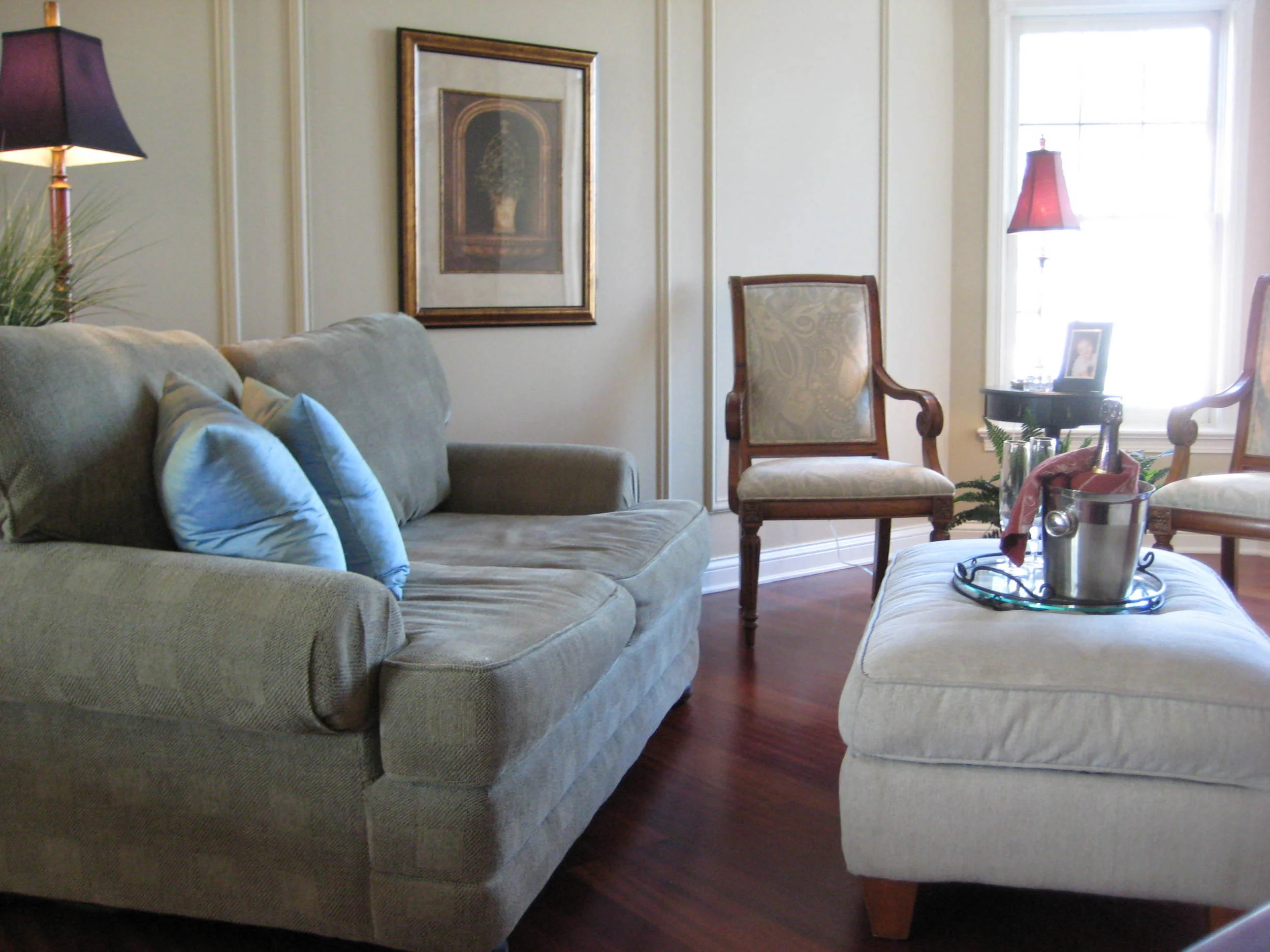 Traditional living room, serving tray, wall panels, upholstered loveseat, side chair, ottoman