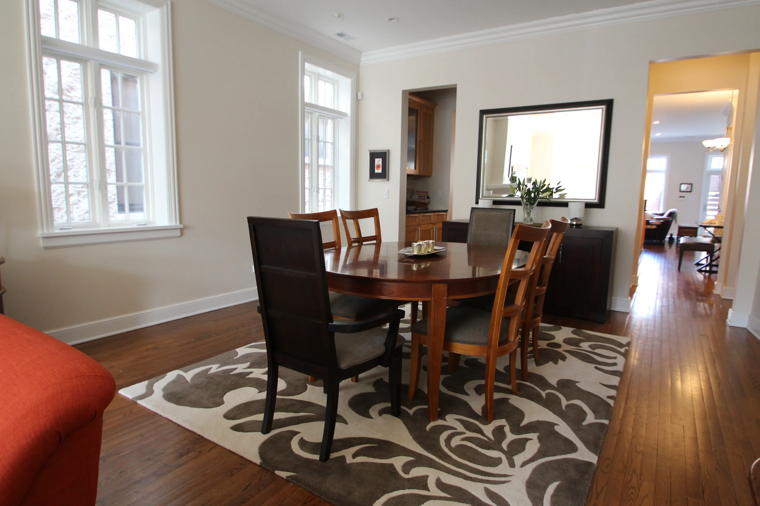 Grand Damask rug, mixed woods, dining room, large mirror