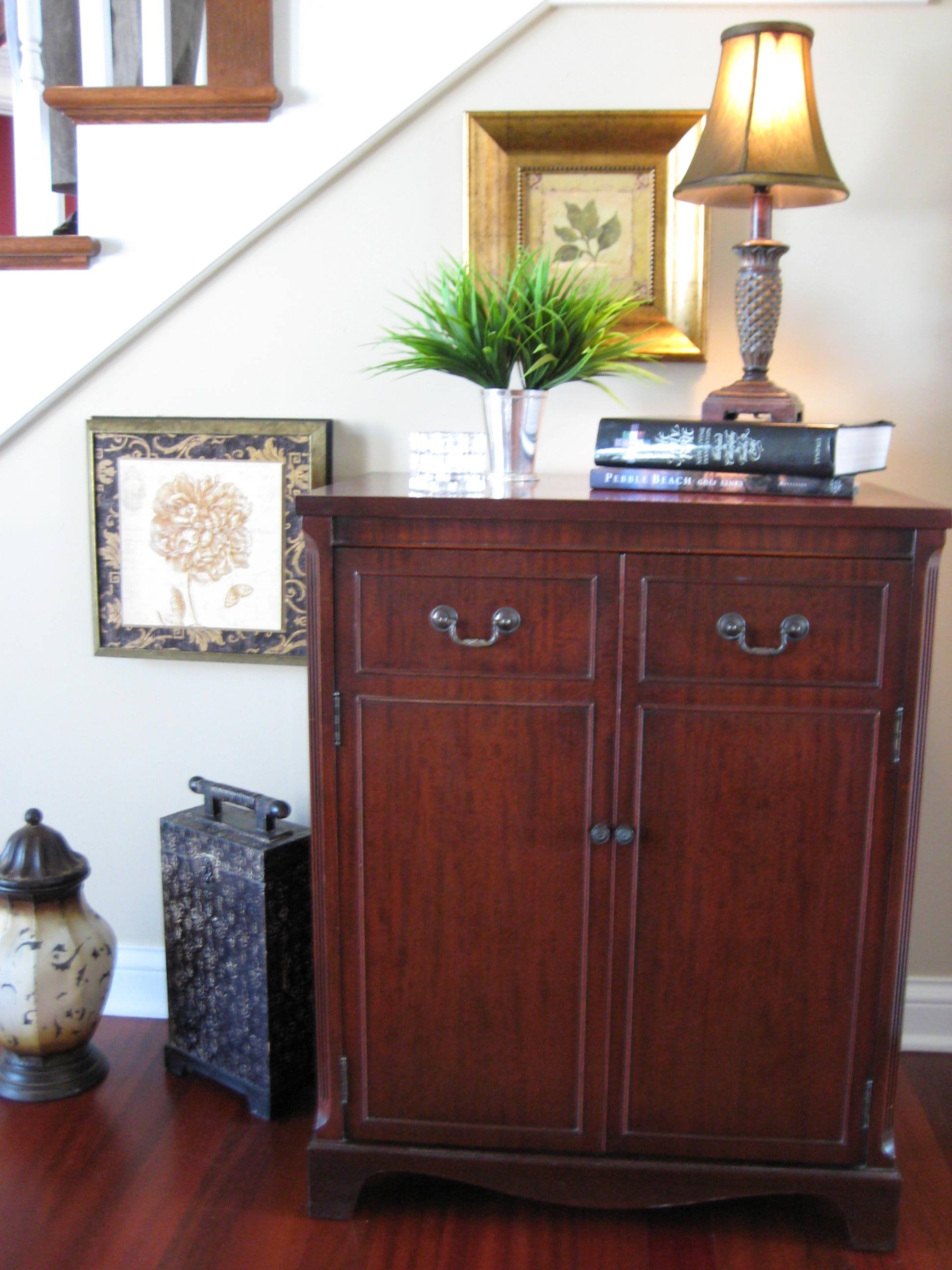 Staircase vignette, greenery, books, cabinet, square artwork, Asian accessories
