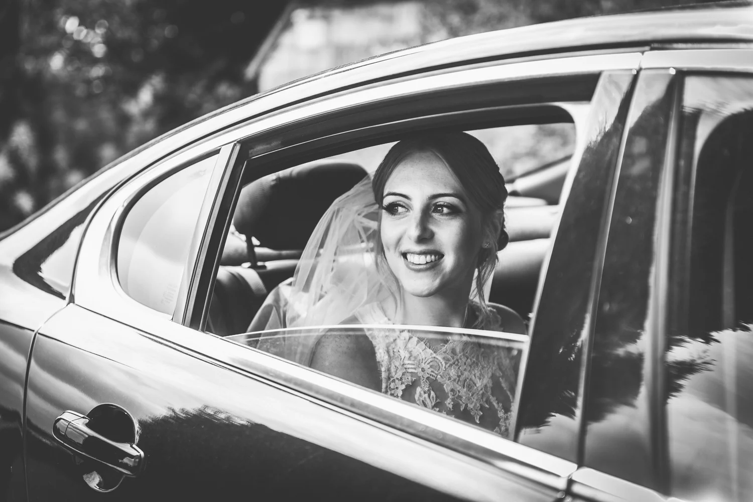 monochrome image of bride arriving to get married in the cotswolds