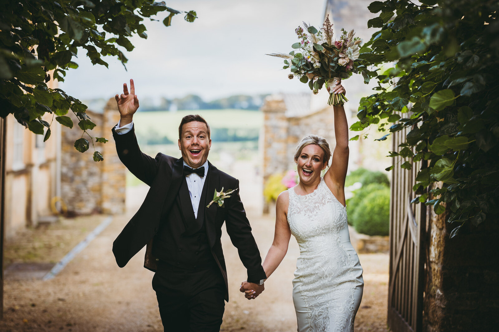 husband and wife raise arms to celebrate their marriage