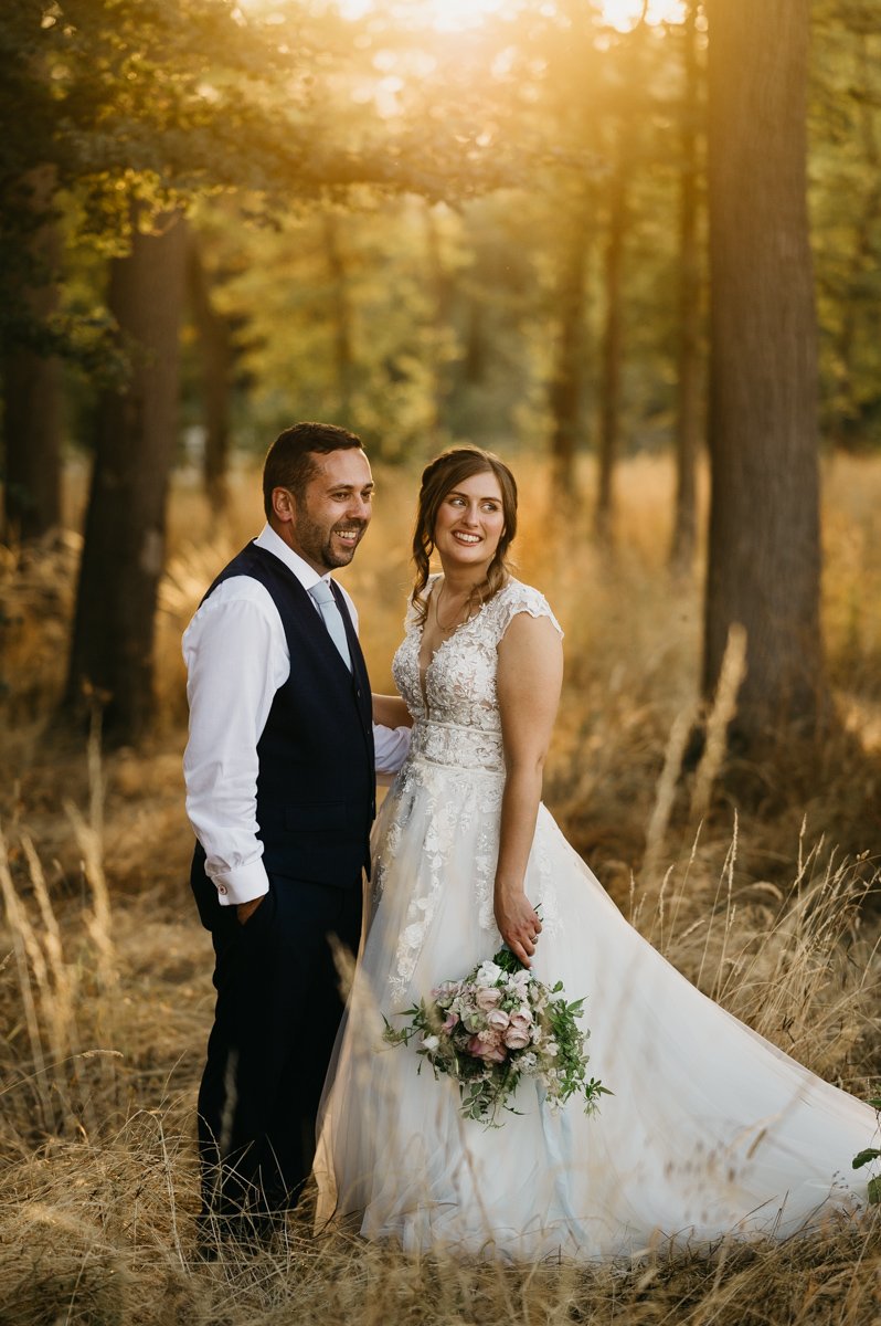 portrait of bride and groom in woodland during sunset at barns and yard