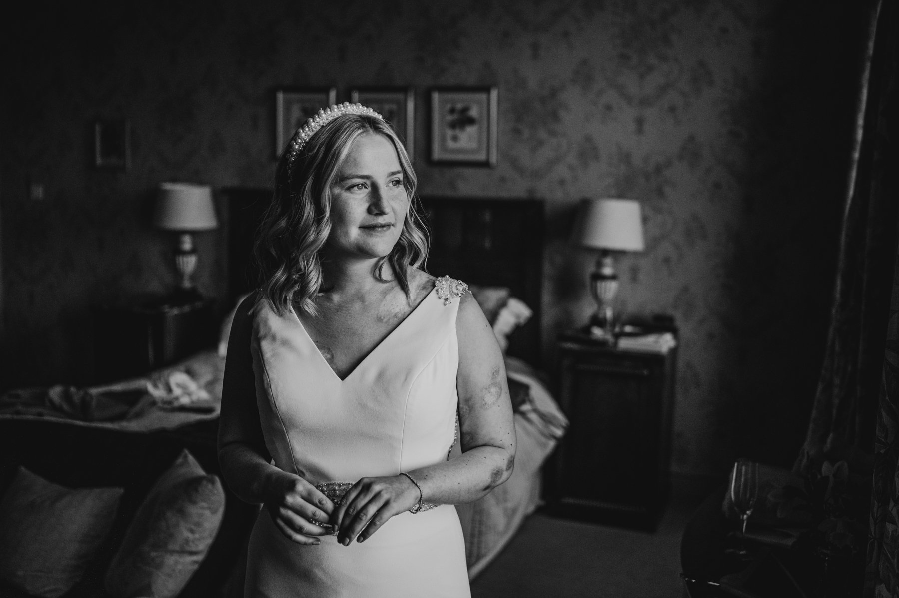 a bride looks out of window in her bridal suite