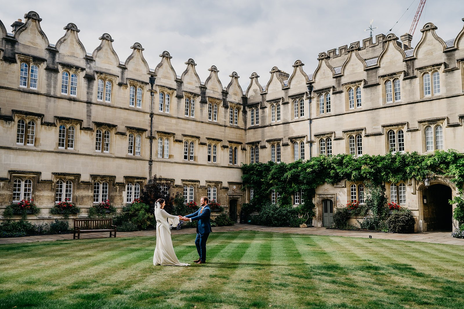 a bride and her husband dance on lawn at Oxford university