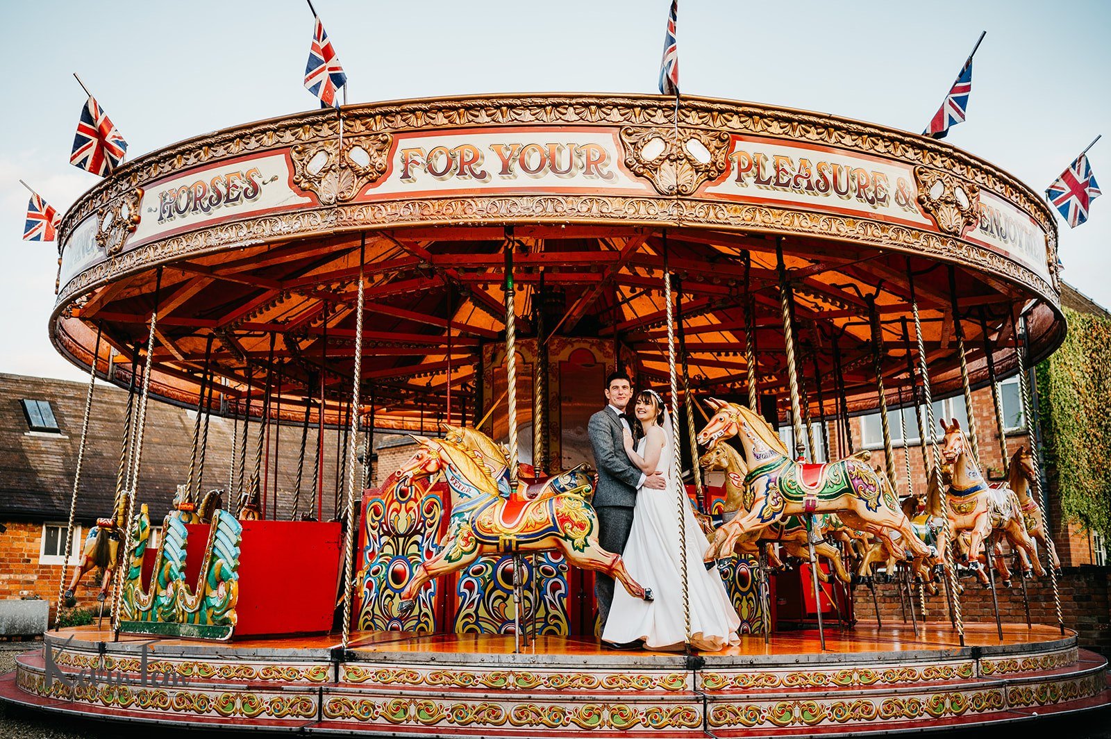 bride and groom fairground carousel portrait on their wedding day