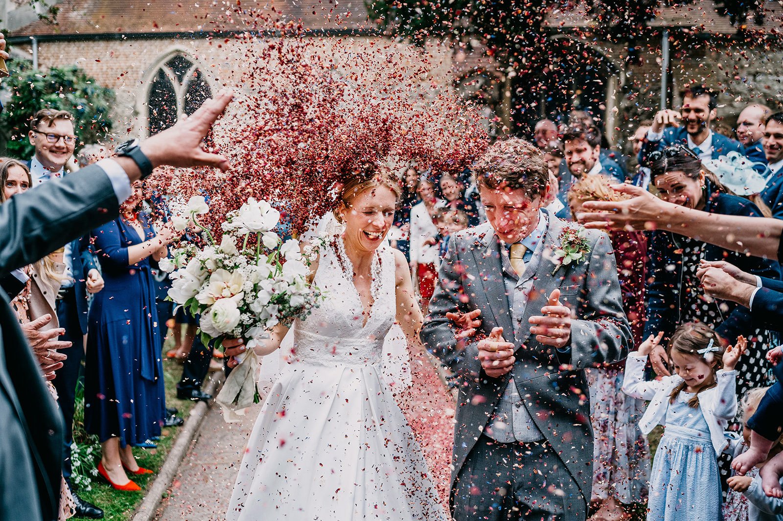 having just said their vows in a London church this couple have confetti thrown at them