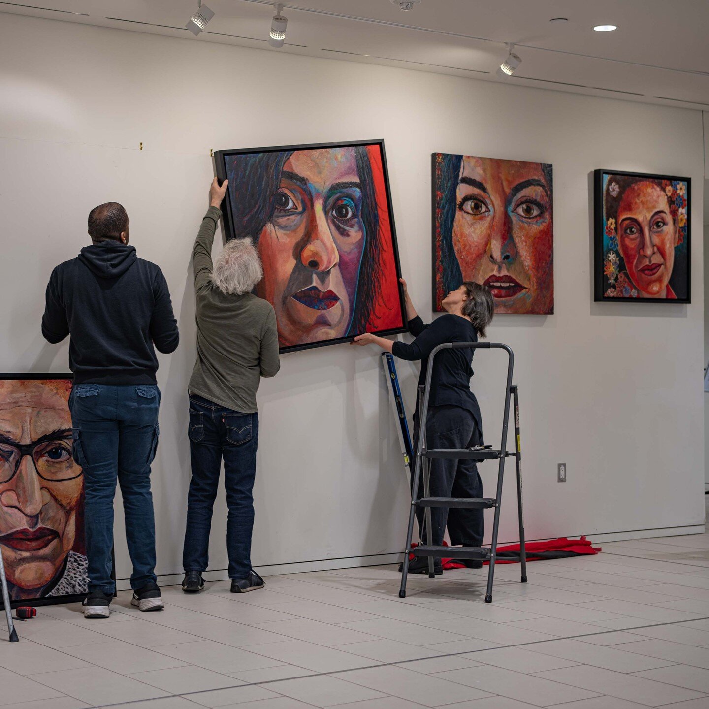 Let me know if you're enjoying these installation shots. For me it's rather fun seeing the exhibition take shape. Here we are installing my encaustic painting Echoes of the Sabine Women &mdash; Impression of Nadia Murad. Many thanks again to Jacques 