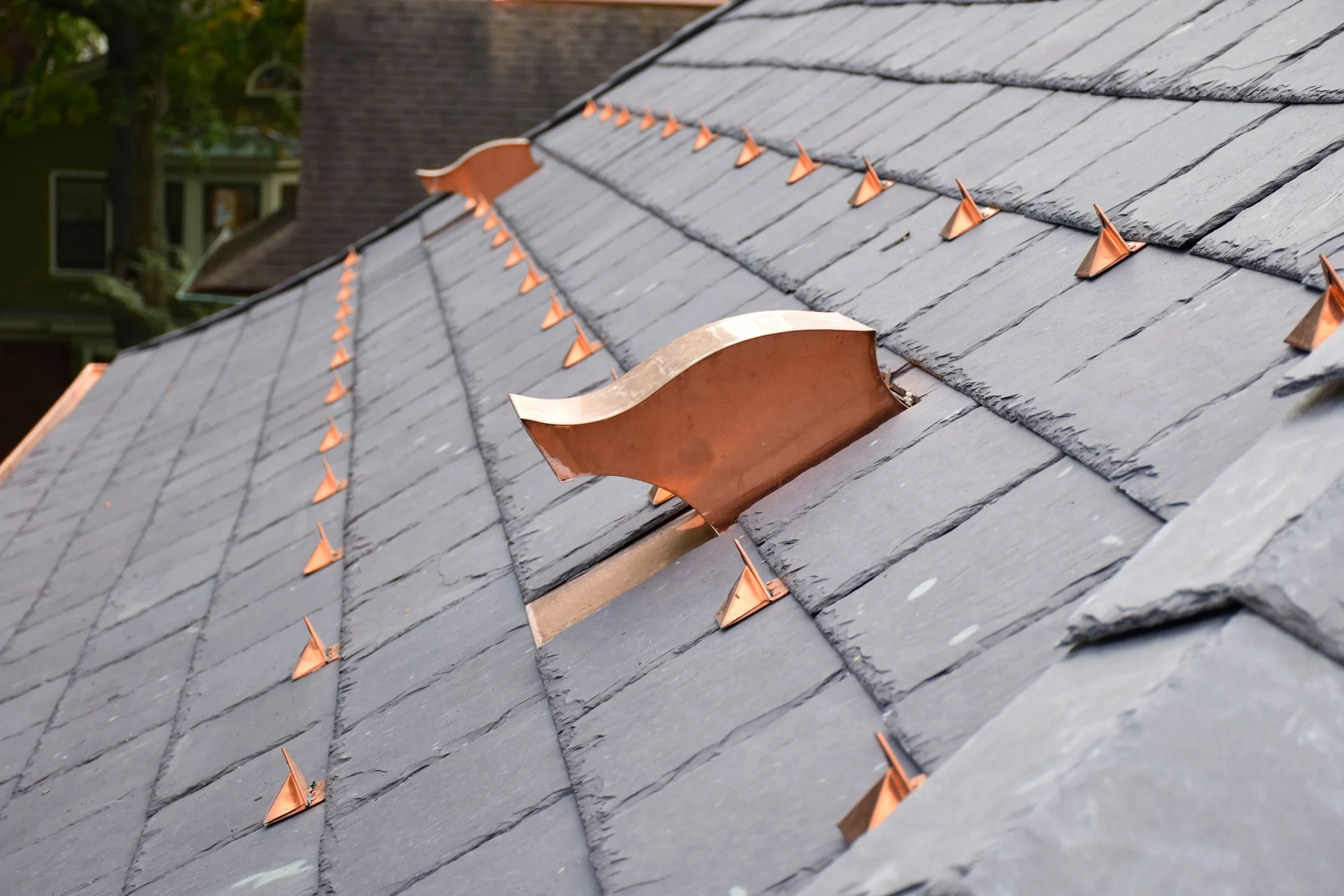 Welsh slate accented with copper snow guards, and vents.