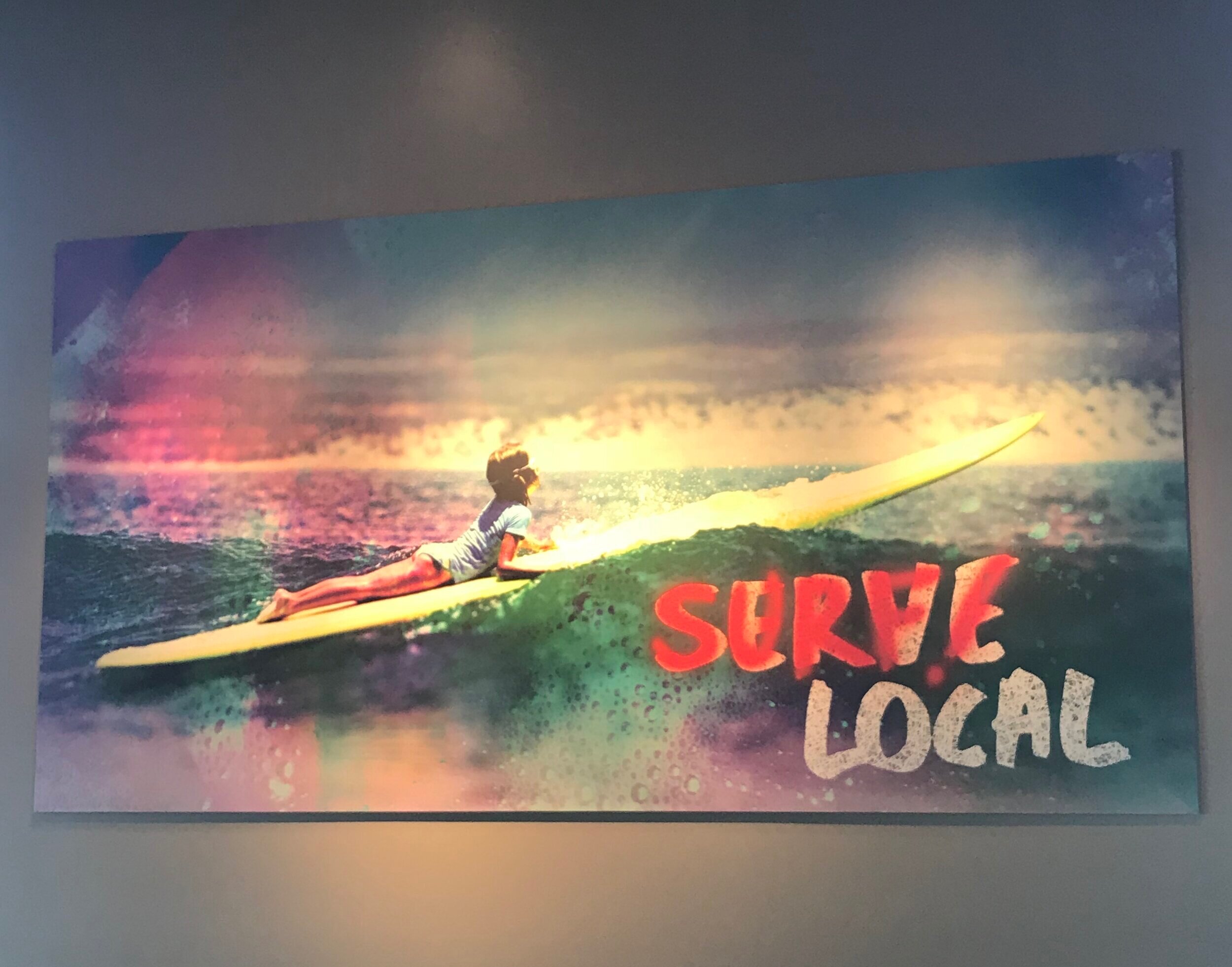 my daughter paddling out in scorpion bay, baja sur. now art at mod pizza huntington beach