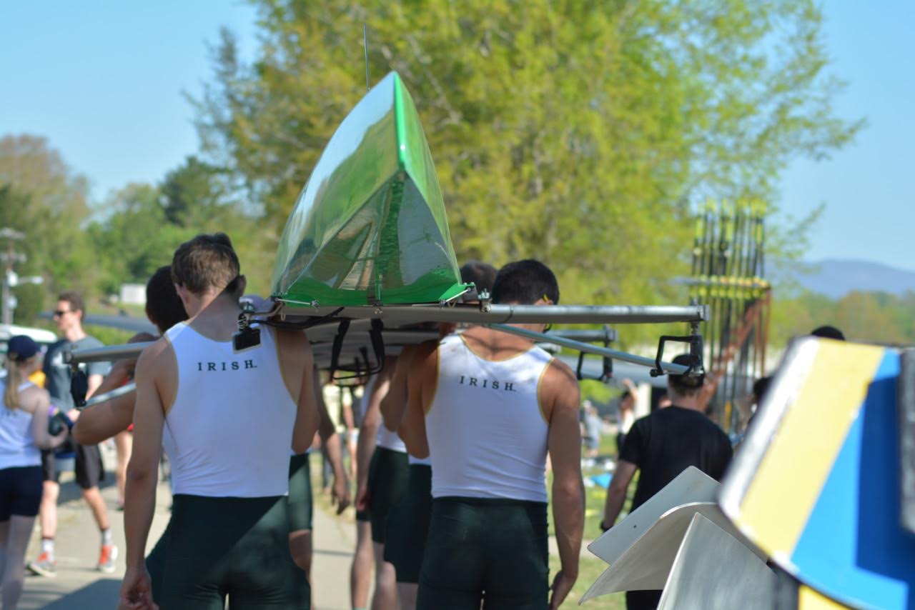 The 2V carries their boat to the dock as they launch for the grand final at the SIRA Championships.