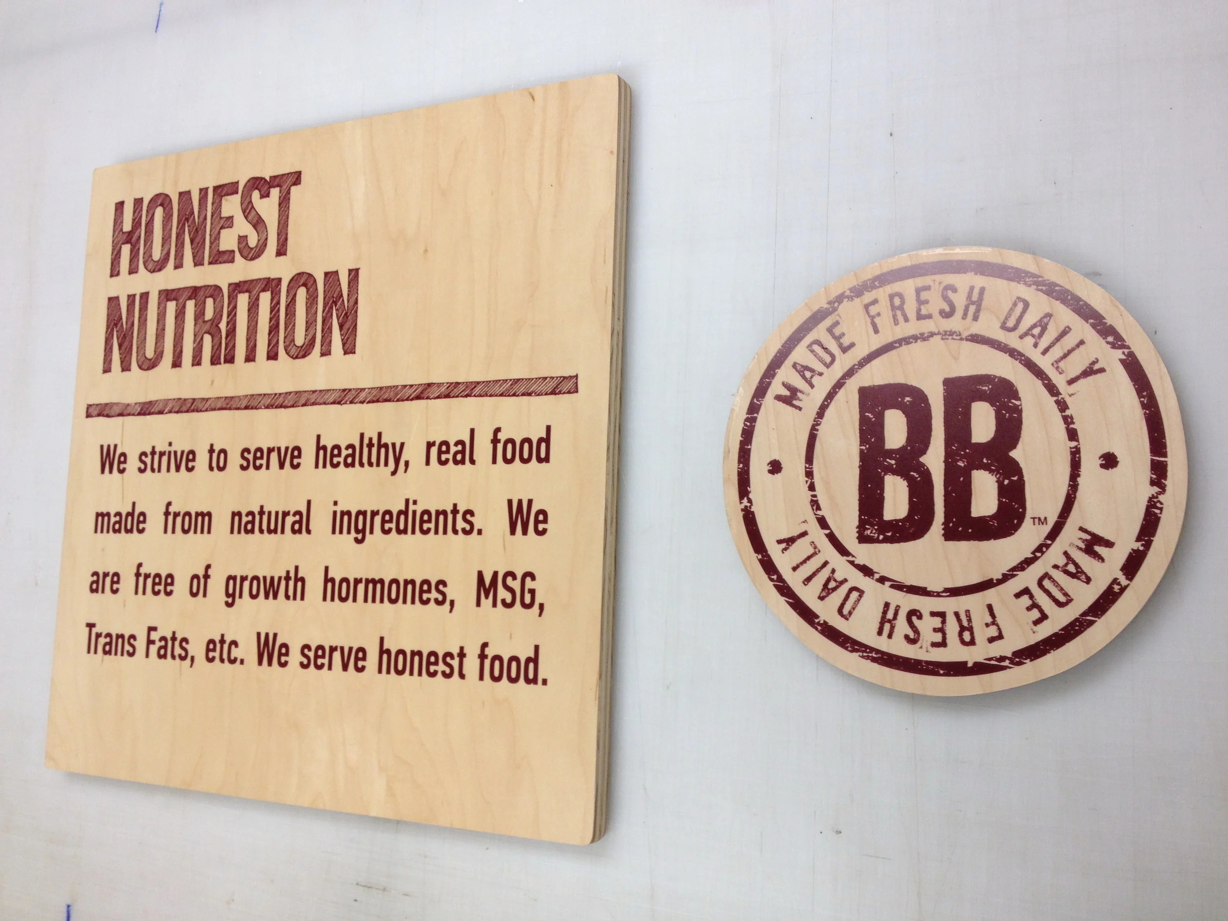 Full color prints on clear vinyl applied to client-supplied wood