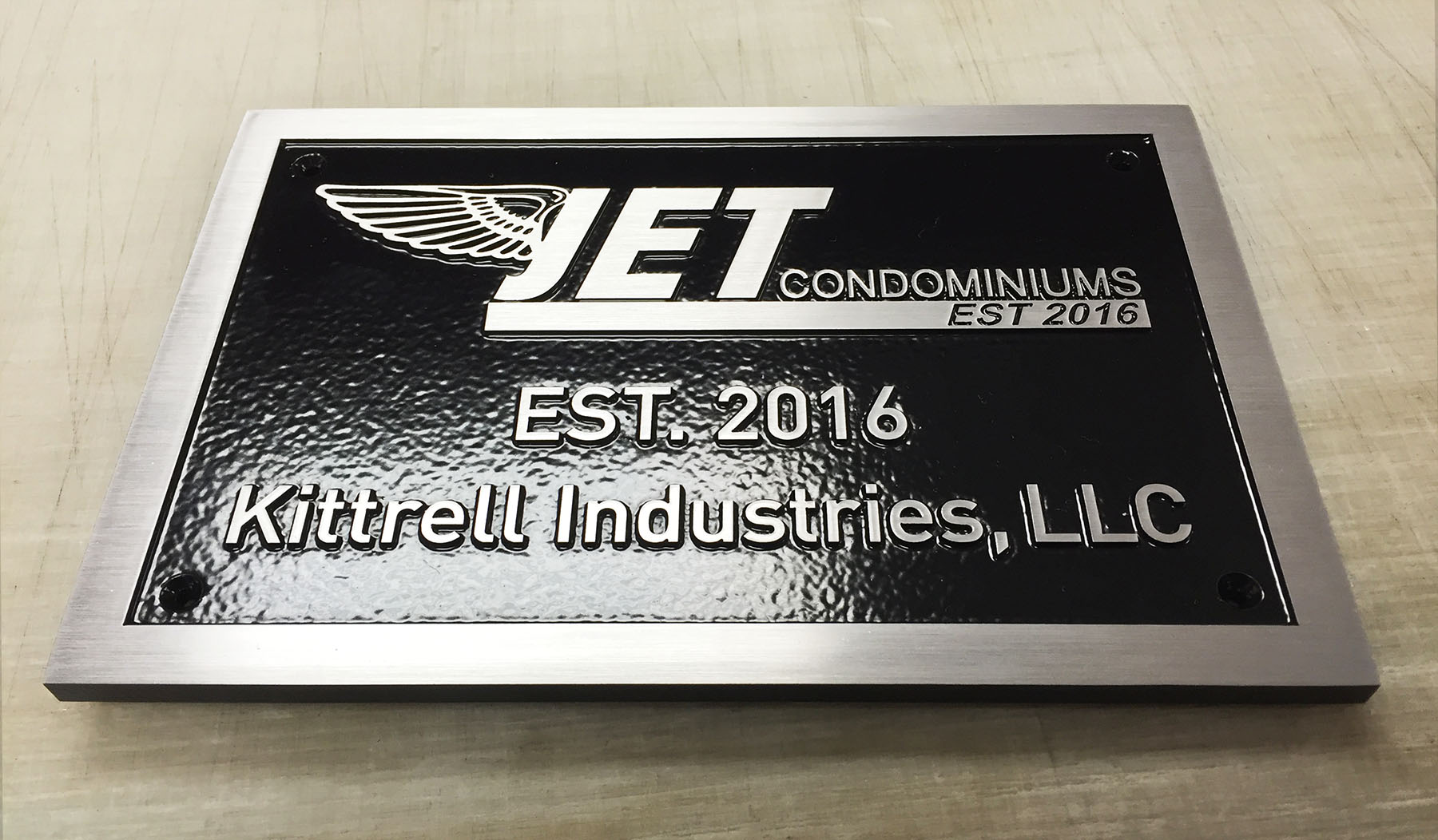 Plaque: 1/4" thick solid brushed aluminum. Painted black, leatherette texture