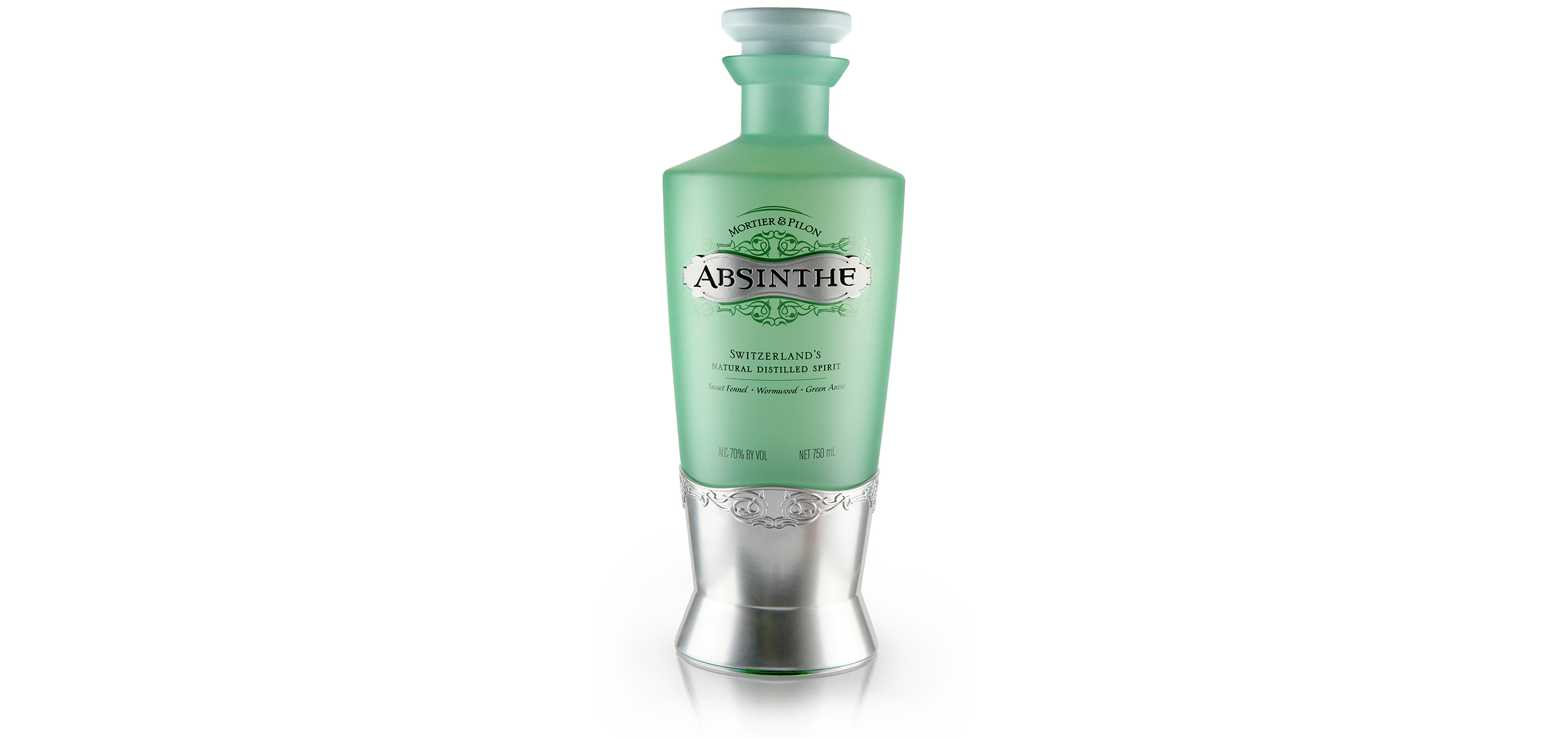 Mortier & Pilon embraces the apothecarian and herbal heritage of the absinthe spirit. The frosted glass and soft celadon color palette paired with silver adornment creates a premium and yet approachable aesthetic. Its shorter chalice-like proportion and cork-like stopper helps to communicate the preciousness of the elixir within and the additional graphic filigree abstractly emphasizes the natural quality of the product. Holistically, this package depicts the often misunderstood spirit of absinthe in a much more favorable and homeopathic light, extending its relevance to a broader target.