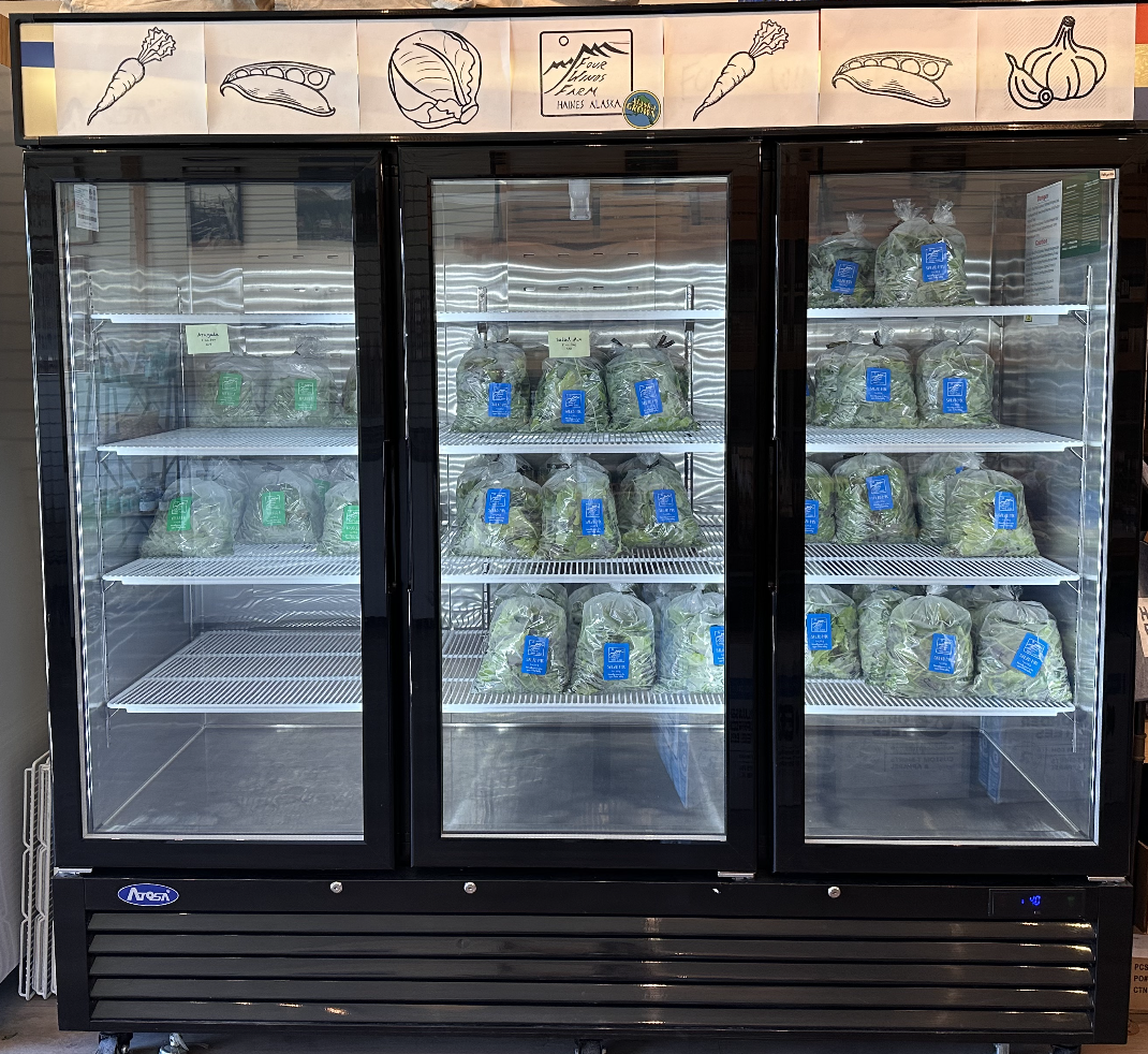 fridge containing salad greens