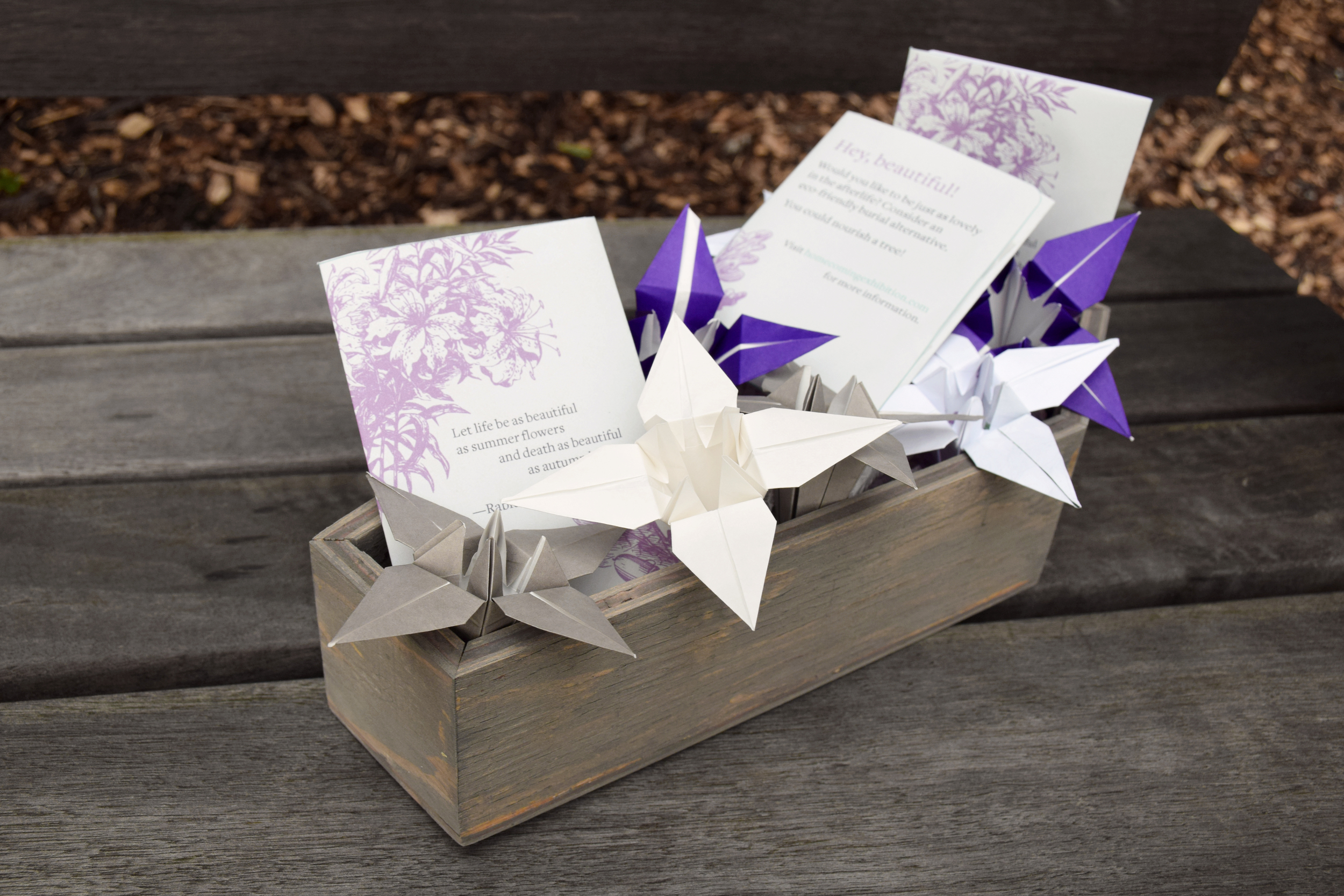 Take-home pieces from the exhibition emphasize "new life", rather than death and include origami lilies and seed packets that direct visitors to the Homecoming exhibition's website, where more information on eco burials is available.