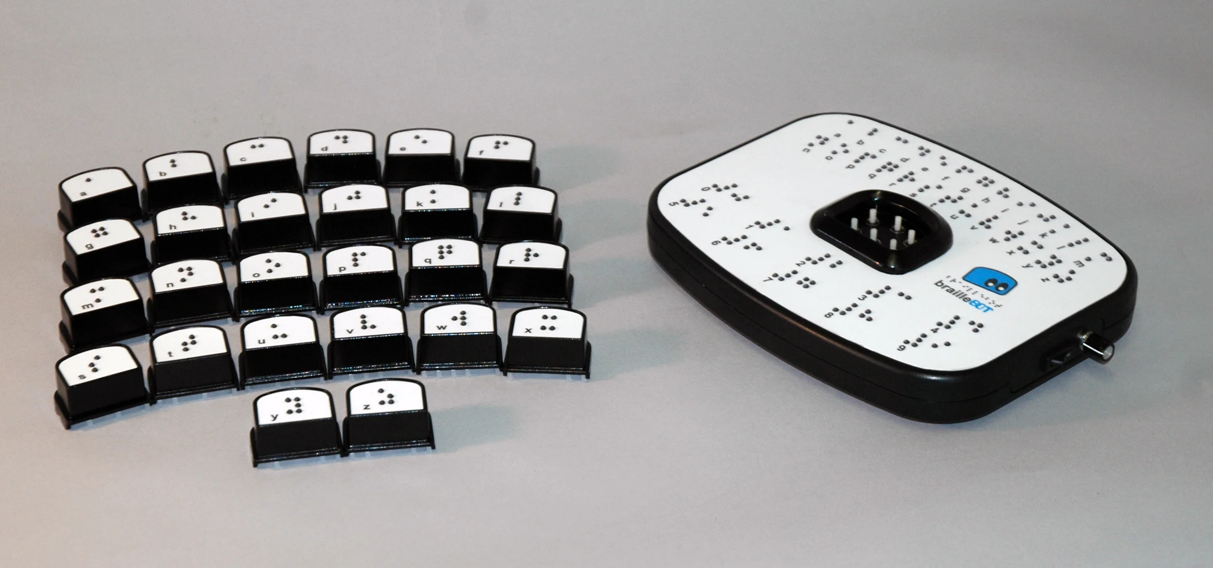 Complete braille alphabet set of brailleblox and prototype of braillebot braille song generator