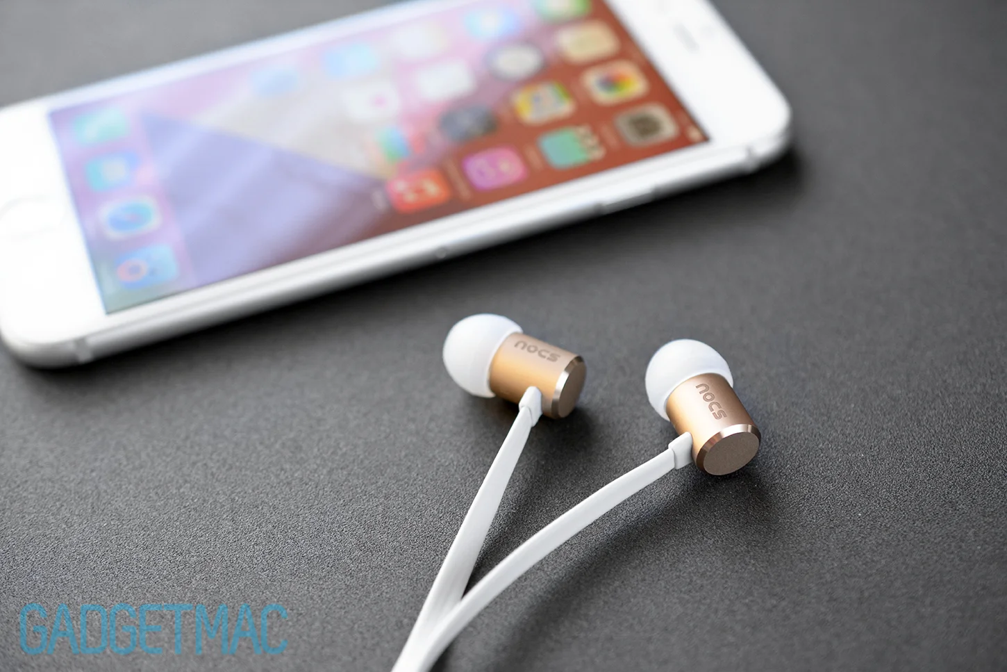 nocs-ns500-aluminum-gold-in-ear-headphones-with-iphone-6.jpg