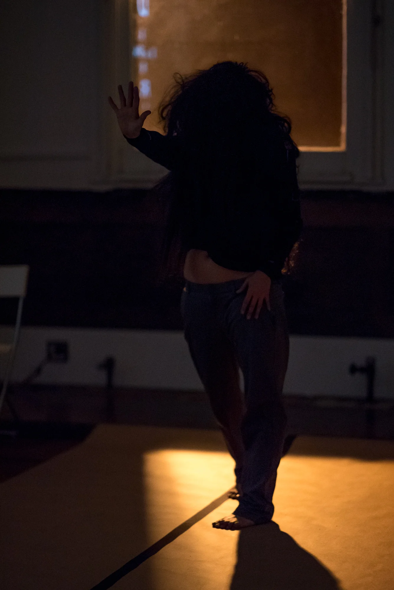 In .bury.me.fiercely. (2018) Tolentino improvises to an accompanying projection of each of the names of The Hard Corps artists as a form of tribute and to unveil a physical imprint of their processes as an archive. Photo by Hillary Goidell.