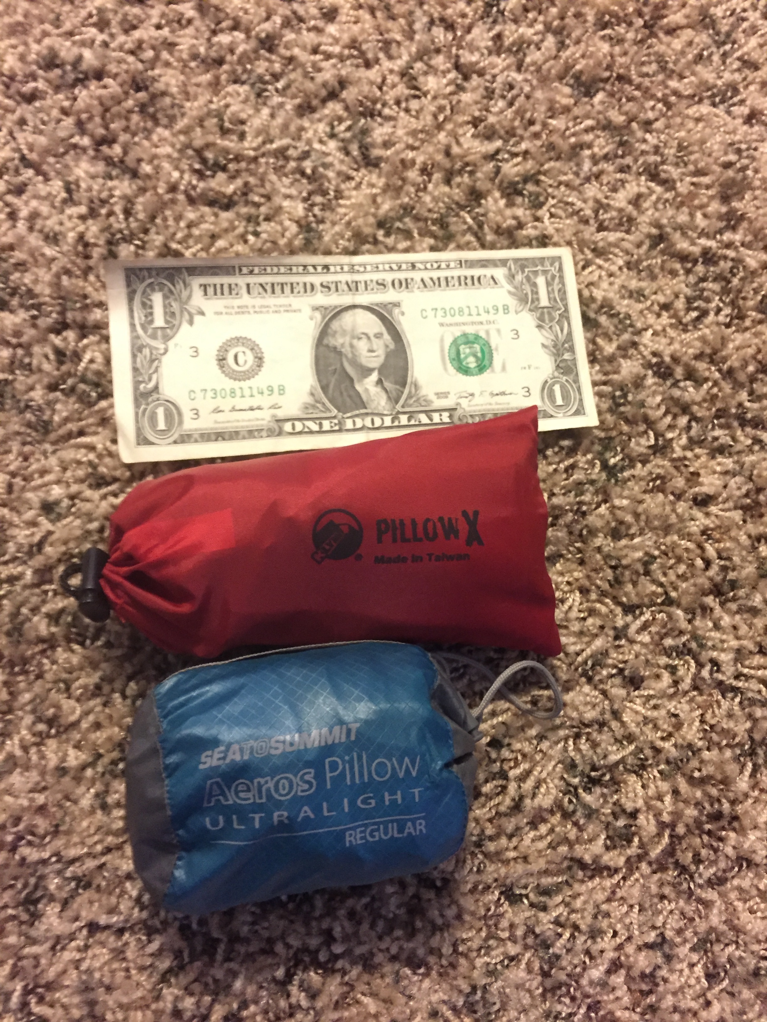 A dollar bill for scale of the size of the pillows in the stuff sacks - both pillows come with them. 