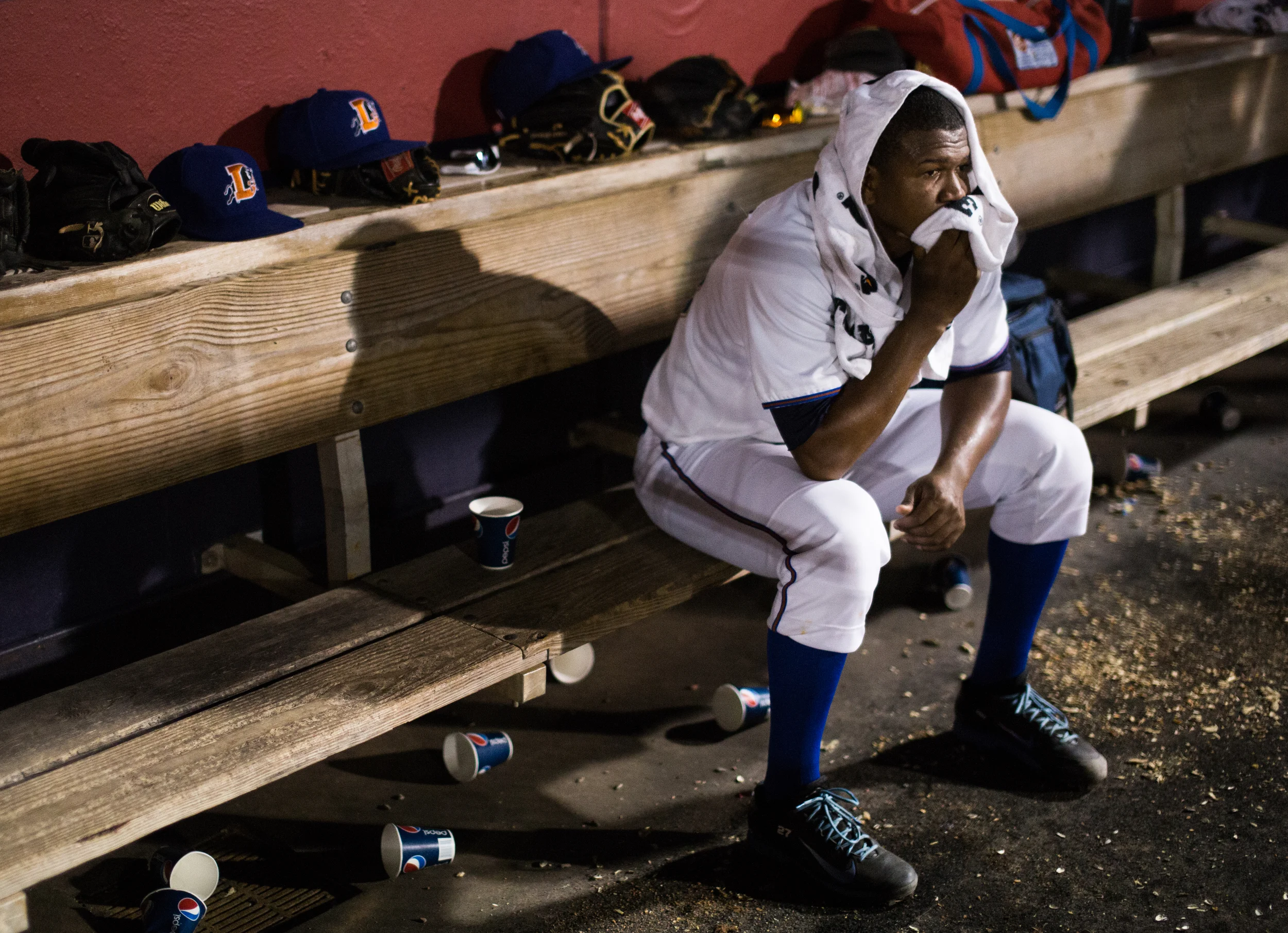 After pitching several consecutive walks, Enny Romero takes a break in the dugout during a game against the Norfolk Tides at the Durham Bulls Athletic Park. 