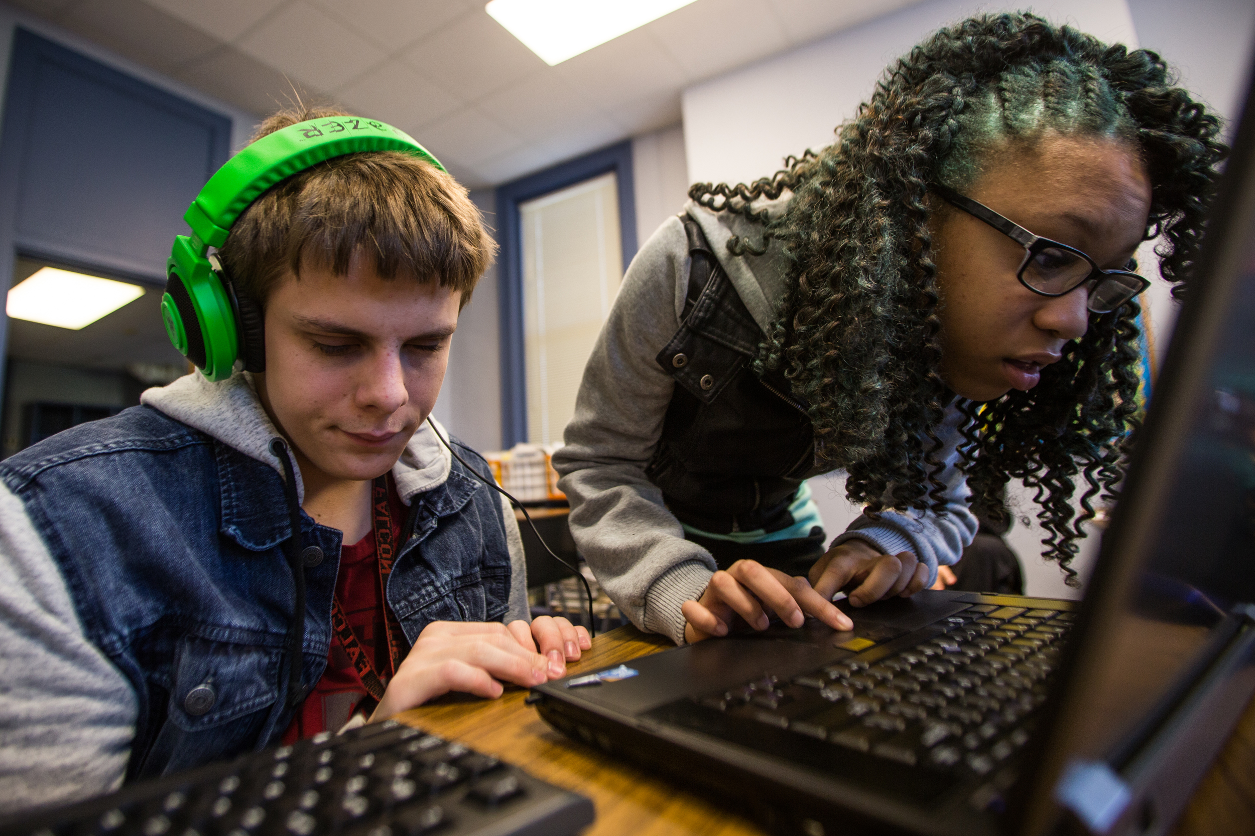  Essence helps her classmate submit an assignment online during a class that consists of just the two of them. "I love the teachers here because they each have something different and most of them are pretty fun