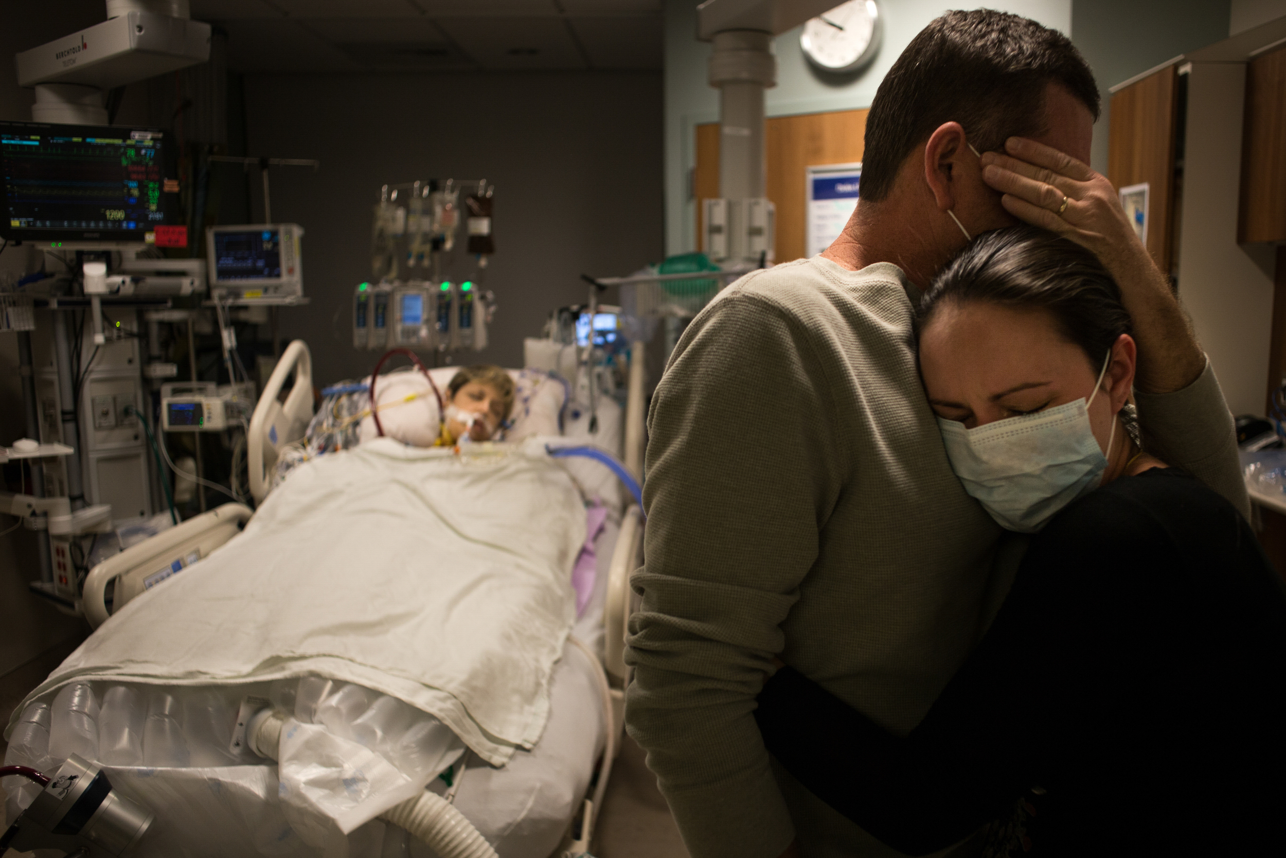 Mitch comforts his and Autum's daughter, Alyssa George, as they see Autum for the first time following the surgery. “It doesn’t really even look like her,” Mitch said after seeing his wife.