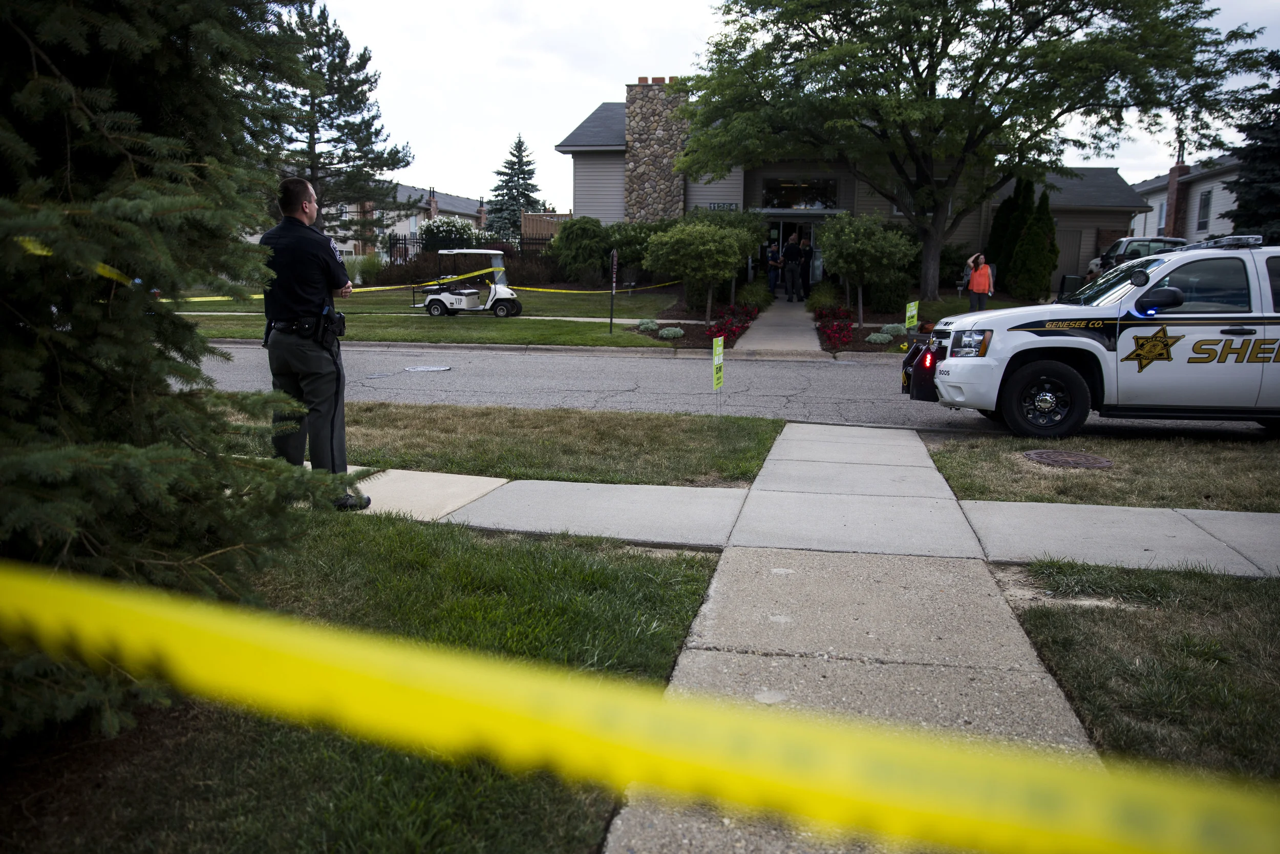 Officers investigate a crime screen after a shooting at Grand Oak Apartments in Grand Blanc on Tuesday, July 26, 2016.