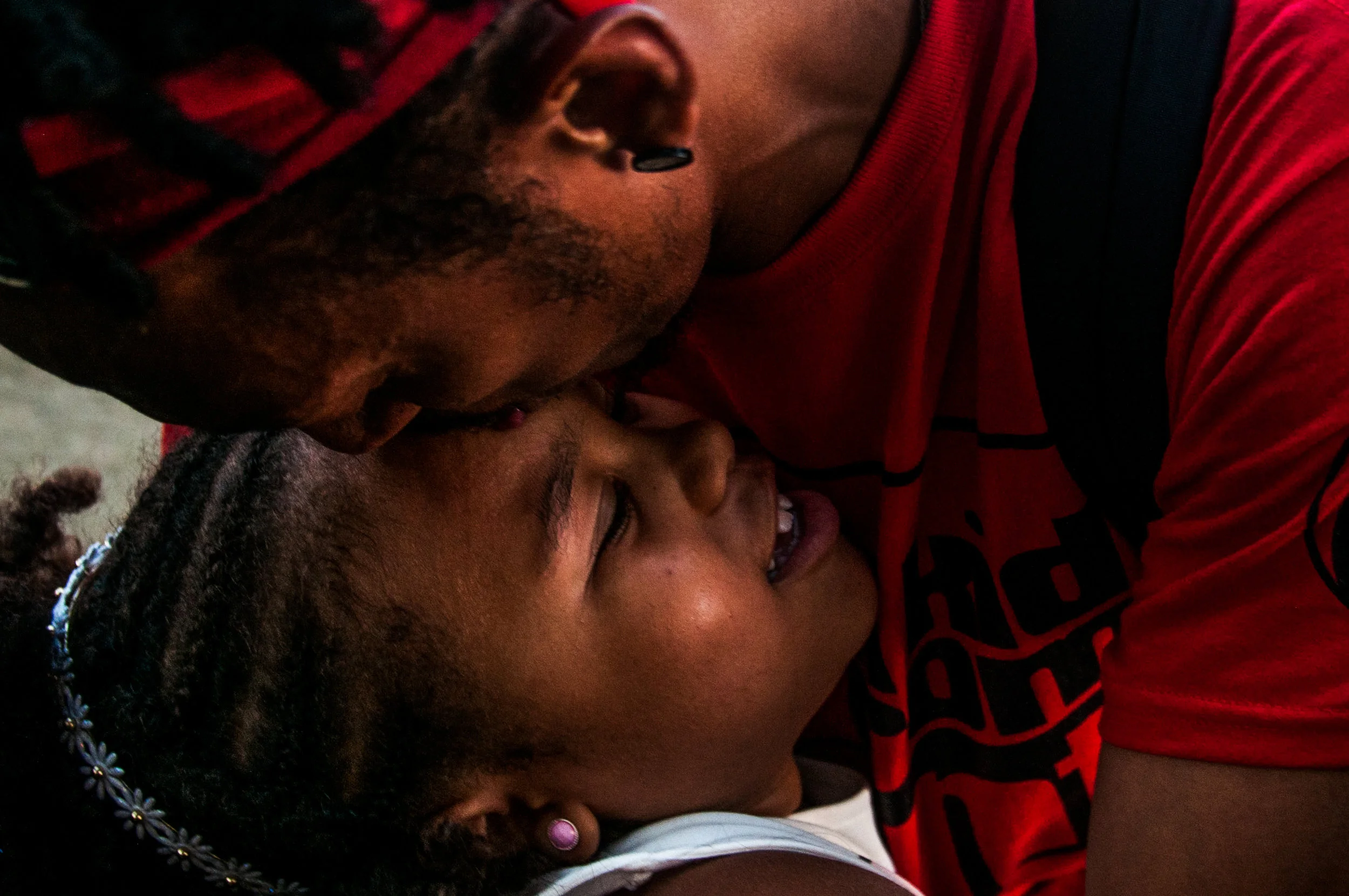 Gerald Barrett, of Flint, give Malaika Bradley, 7, of Flint, a kiss at the annual Flint Jazz Festival on Saturday, Aug. 13, 2016 in Flint. 