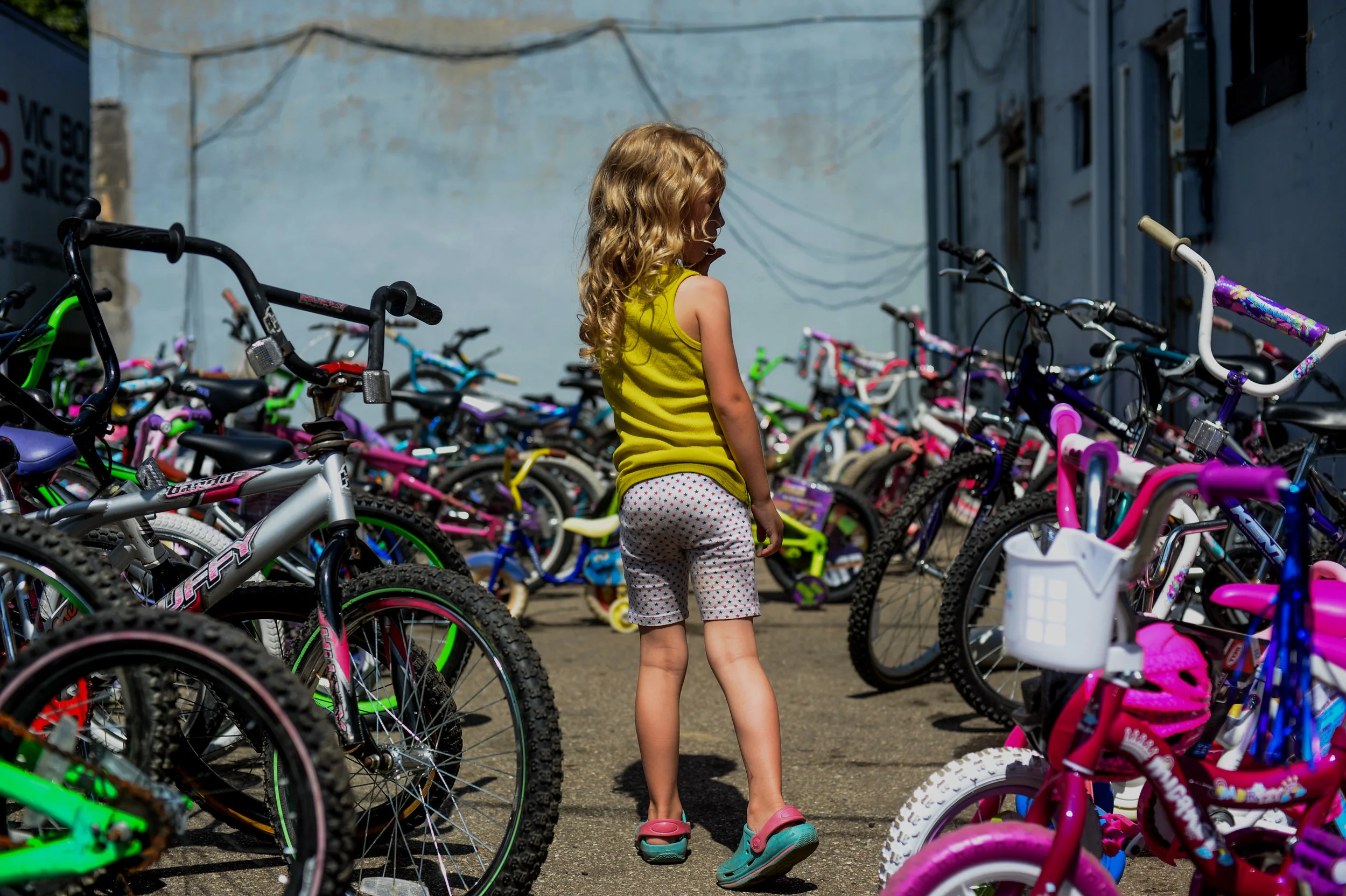 Trinity Jackson, 5, of Flint, looks down the rows of bicycles in the back parking lot of Krystal Jo's Diner for the business's Second Annual Bicycle Giveaway on Sunday, Aug. 28, 2016 in Flint. Over 150 bicycles were collected to giveaway to children in the community through a raffle.