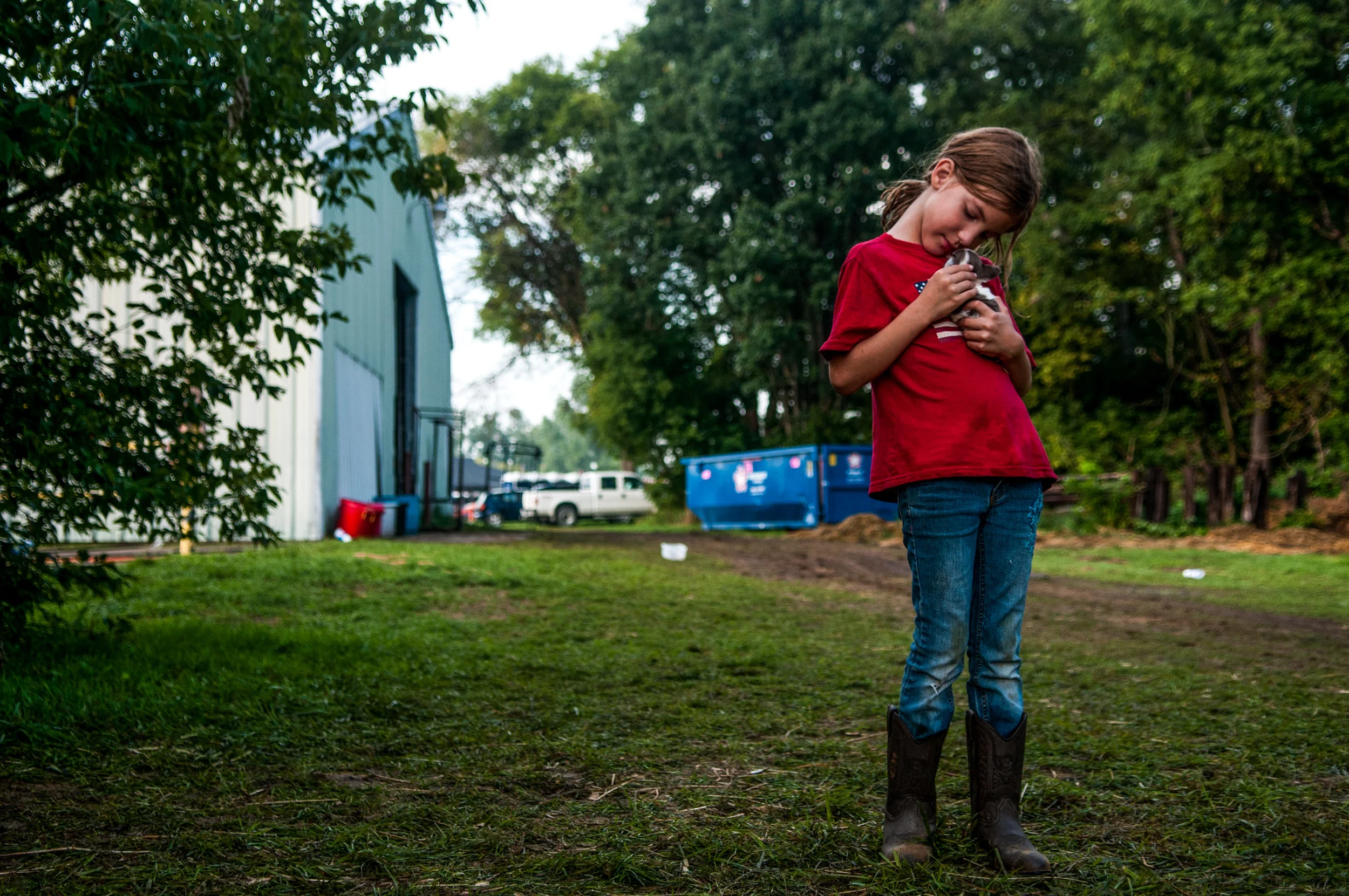 Reagan Persails, 7, of Otter Lake, holds a puppy while at the Genesee County Fair on Wednesday, Aug. 24, 2016 at the E.A. Cummings Center in Mount Morris. 