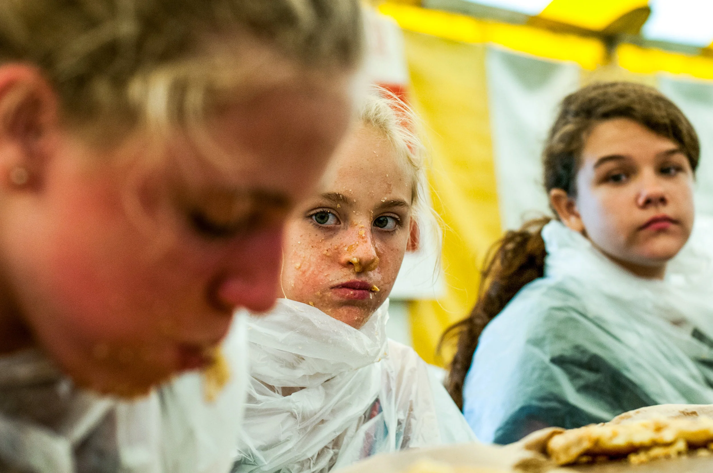Pie eating champion Analiese Armbrust, 12, of Millington, left, devours her apple pie while runner-up Kierstynn Hutchinson, 11, of Mt. Morris, center, and Lilly Cain, 12, of Mt. Morris, watch during the youth pie eating contest at the Genesee County Fair on Wednesday, Aug. 24, 2016 at the E.A. Cummings Center in Mount Morris. 