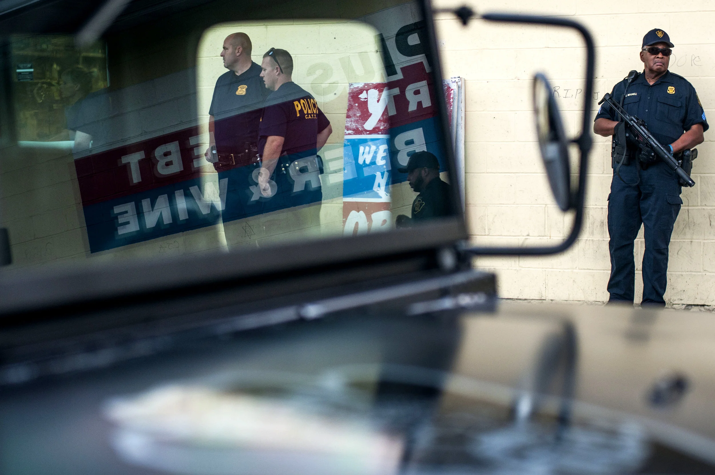 Flint police officers padlock Liquor Plus Mini Mart after a temporary restraining order was granted by Genesee Circuit Judge Judith Fullerton against the business and its owner on Tuesday, Aug. 23, 2016 in Flint's north side. Three shootings have occurred outside the Liquor Plus Mini Mart since July 29, including the death of 27-year-old Corandis Jenkins, a teenager shot at a vigil for Jenkins and a 10-year-old who was shot inside a vehicle. The restraining order is valid for seven days, in which time Genesee County Prosecutor David Leyton will try to have the business closed for an extended period of time.