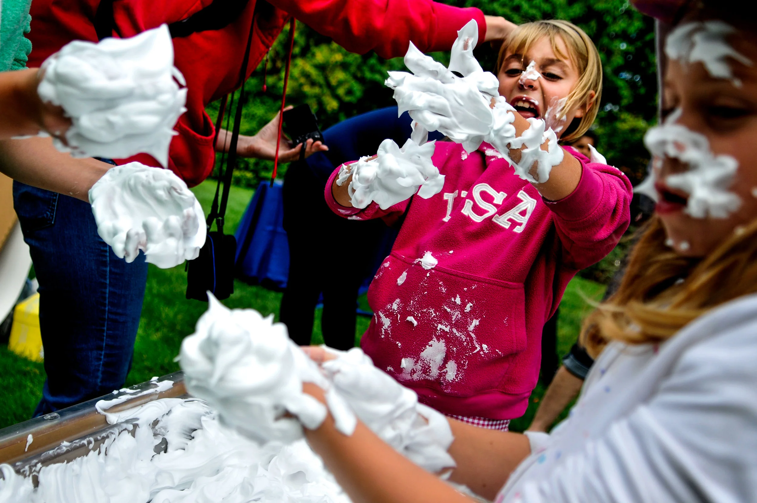 Anna Masen, 9, of Troy, plays in a box of shaving cream with her sisters during the 15th annual Fall Harvest Festival on Saturday, Sept. 24, 2016 at Applewood Estate in Flint.