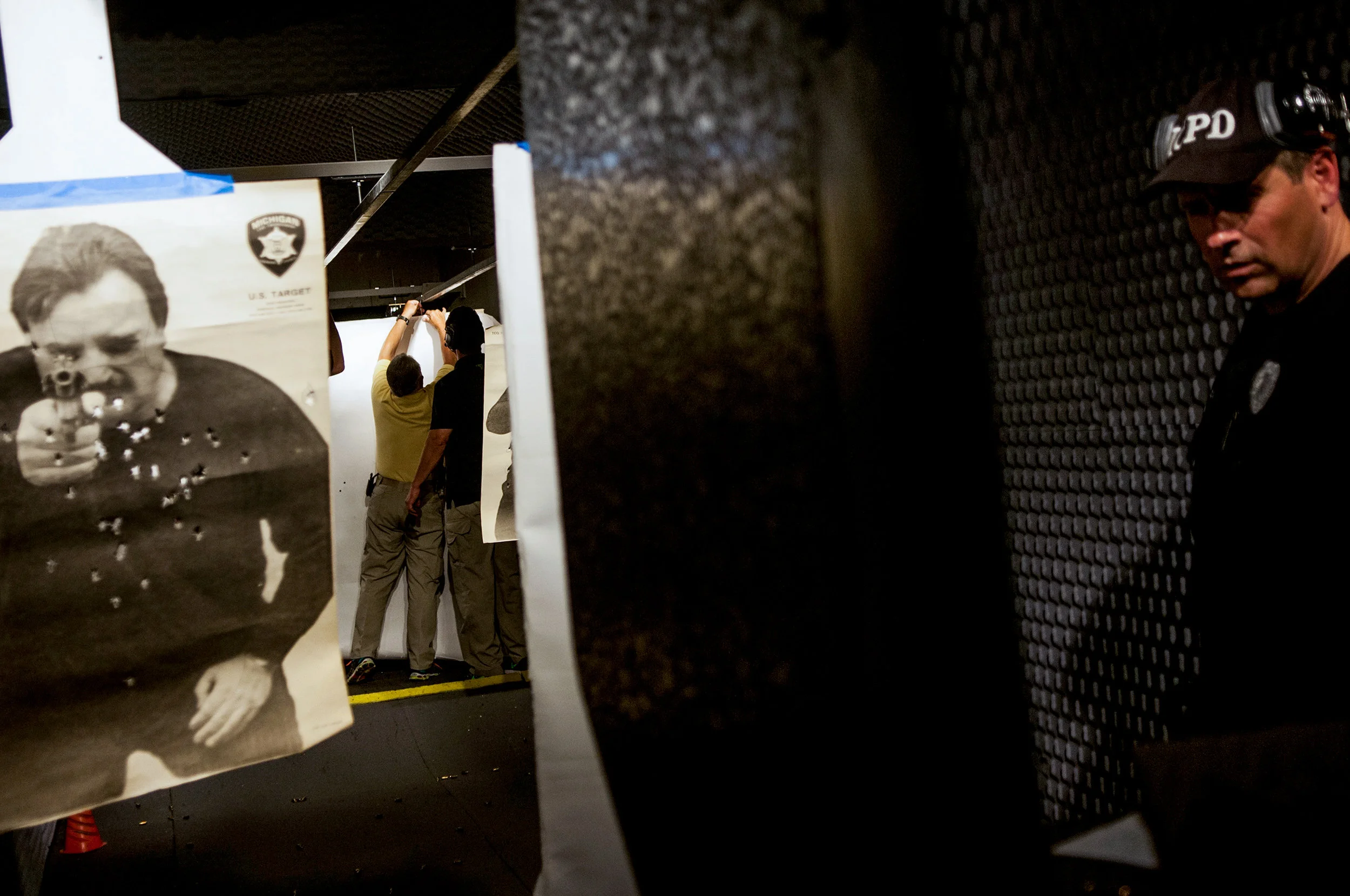 Imlay City police officer Joe DeLuca, right, attends firearm training at Mobile Tactics Range, a mobile shooting range, on Monday, September 12, 2016 at the Eastern Michigan Fair Grounds in Imlay City. After the Woods and Water event over the weekend, Williams Gun Sight donated two days for local law enforcement agencies' use of the facility for firearm training.