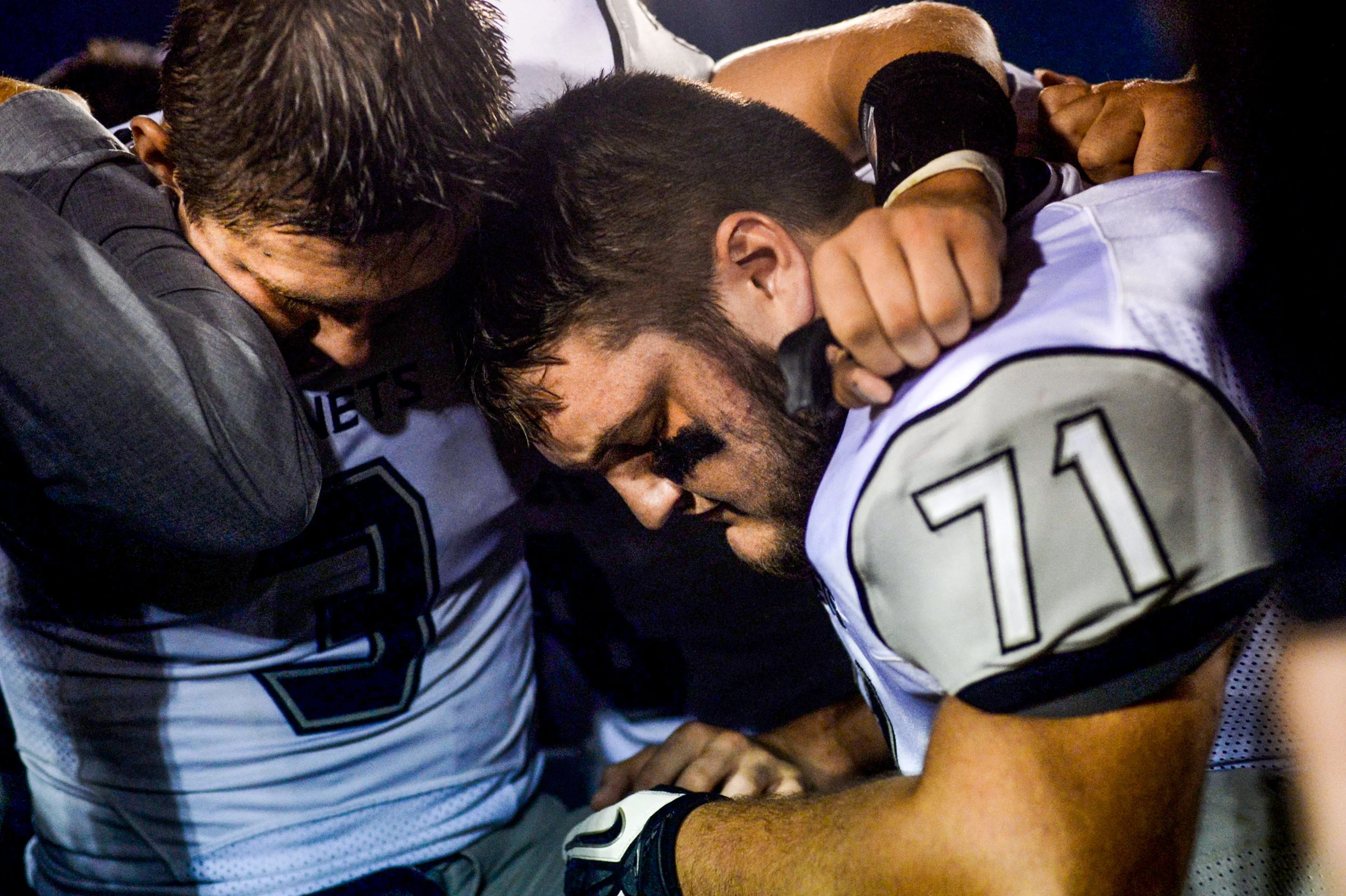 New Lothrop players Mason Ruddy, No. 3, and Travis Indlekofer, No. 71, kneel and pray with their teammates after New Lothrop's victory against Bentley High School on Thursday, Sept. 1, 2016 at Bentley High School in Burton. New Lothrop won 56-0.
