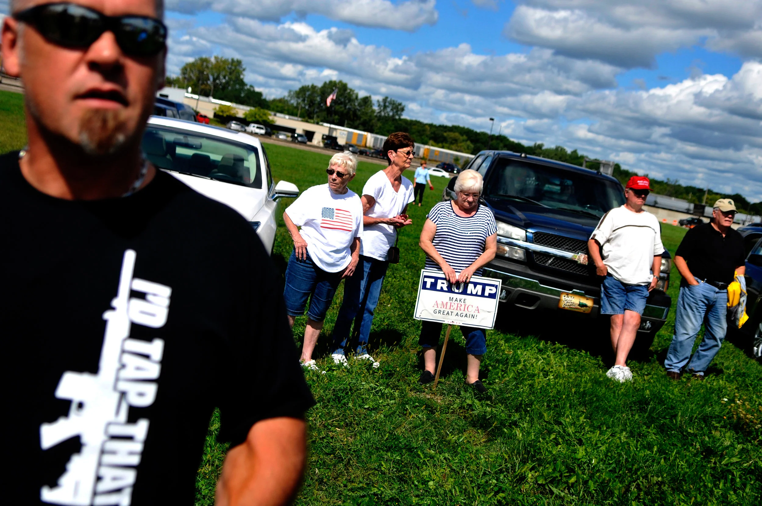 Dozens of people gather outside Bishop International Airport for the arrival of Republican presidential candidate Donald Trump on Wednesday, Sept. 14, 2016 in Flint.