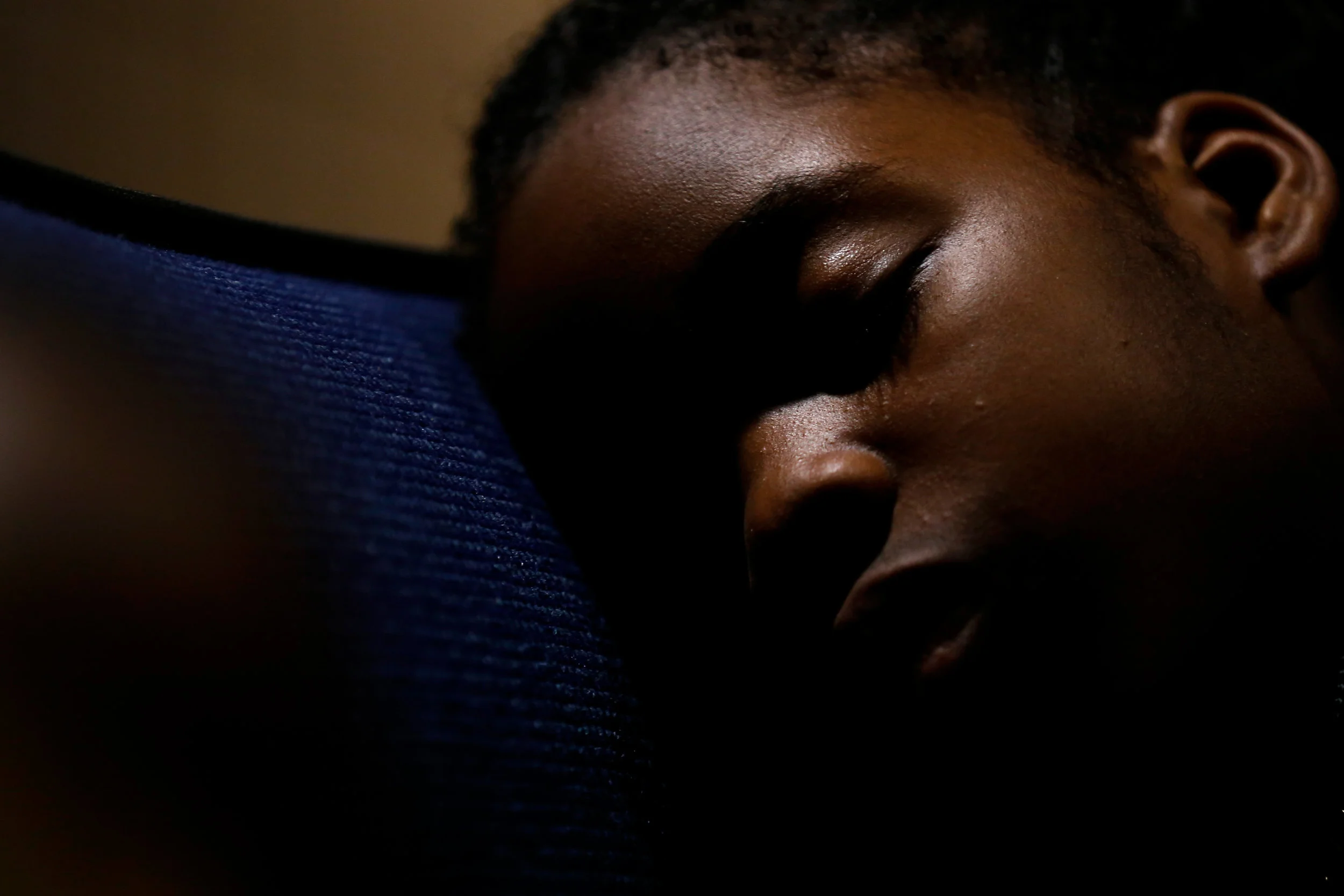 Andrea Enemodia, 9, of Nigeria, sleeps while her family gathers to watch the Presidential debate during a live screening on Wednesday, Oct. 19, 2016 at UM-Flint in downtown Flint. 