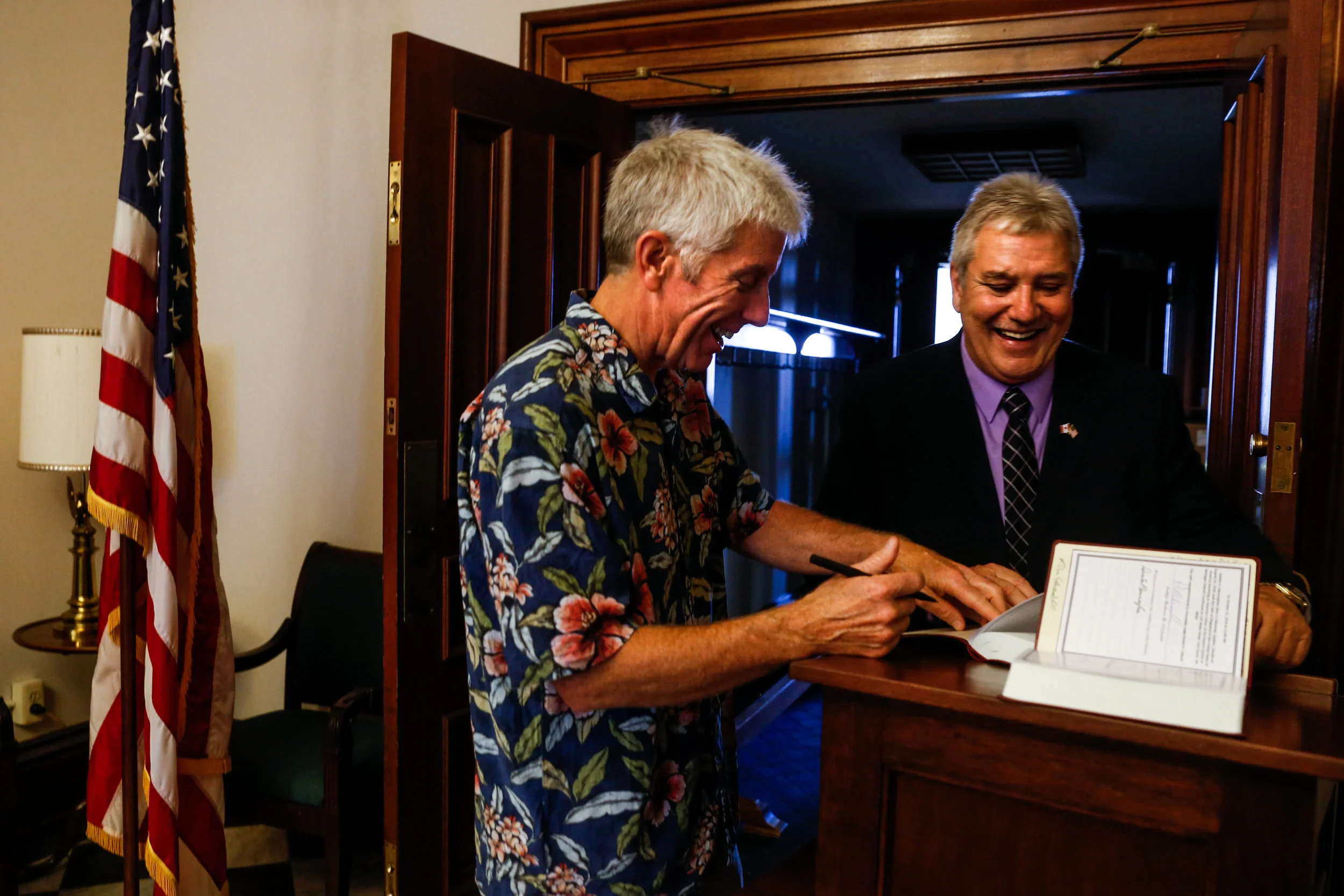 From left, Don Edwards, of Linden, signs a family Bible for Gaetan Manningham, 62, of Mt. Morris, after Manningham swears the oath of citizenship before U.S. District Judge Robert Cleland during a special ceremony on Wednesday, Oct. 12, 2016 at the U.S. District Court for the Eastern District of Michigan in Port Huron. Manningham served in the U.S. Marine Corps for two years and worked for General Motors for nearly 30 years. Last year approximately 13,000 Michigan residents were sworn in as U.S. citizens. 