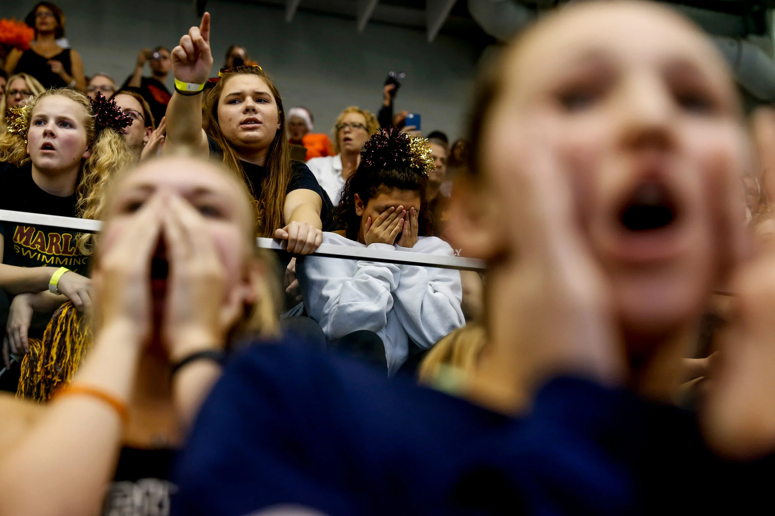Students from Farmington Hills Mercy High School cheer on their friends swimming in the MHSAA D1 girls championship swim meet on Saturday, Nov. 19, 2016 at Oakland University in Rochester. Farmington Hills Mercy High School placed second after Rockford High School was named the MHSAA D1 girls swimming champions. 