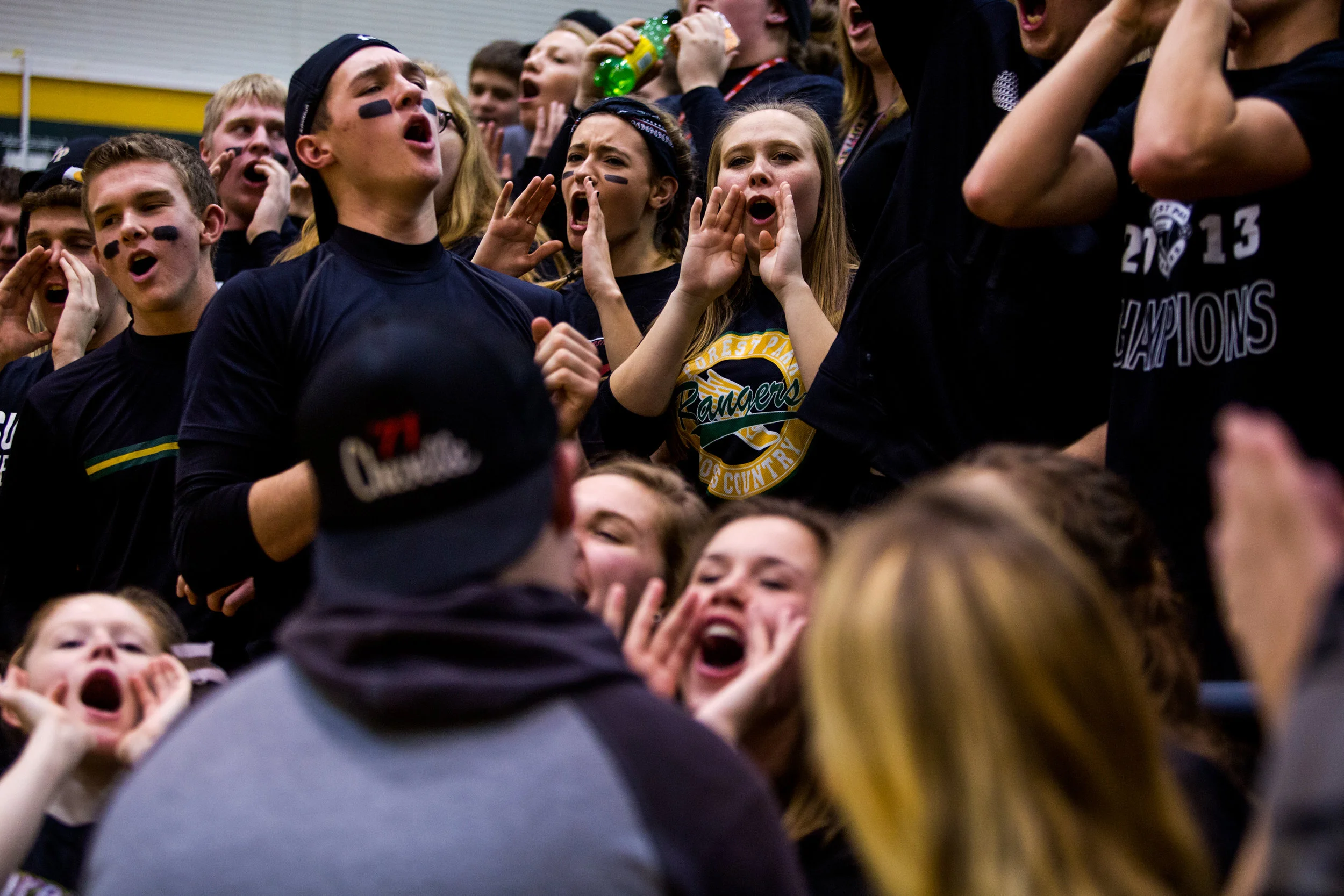 Aliya Haake of Ferdinand, 18, center, stood next to Anna Bailey of Ferdinand, 17, left, while cheering in the student section during Friday night's basketball game at Forest Park High School in Ferdinand. Forest Park defeated South Spencer 62-46.