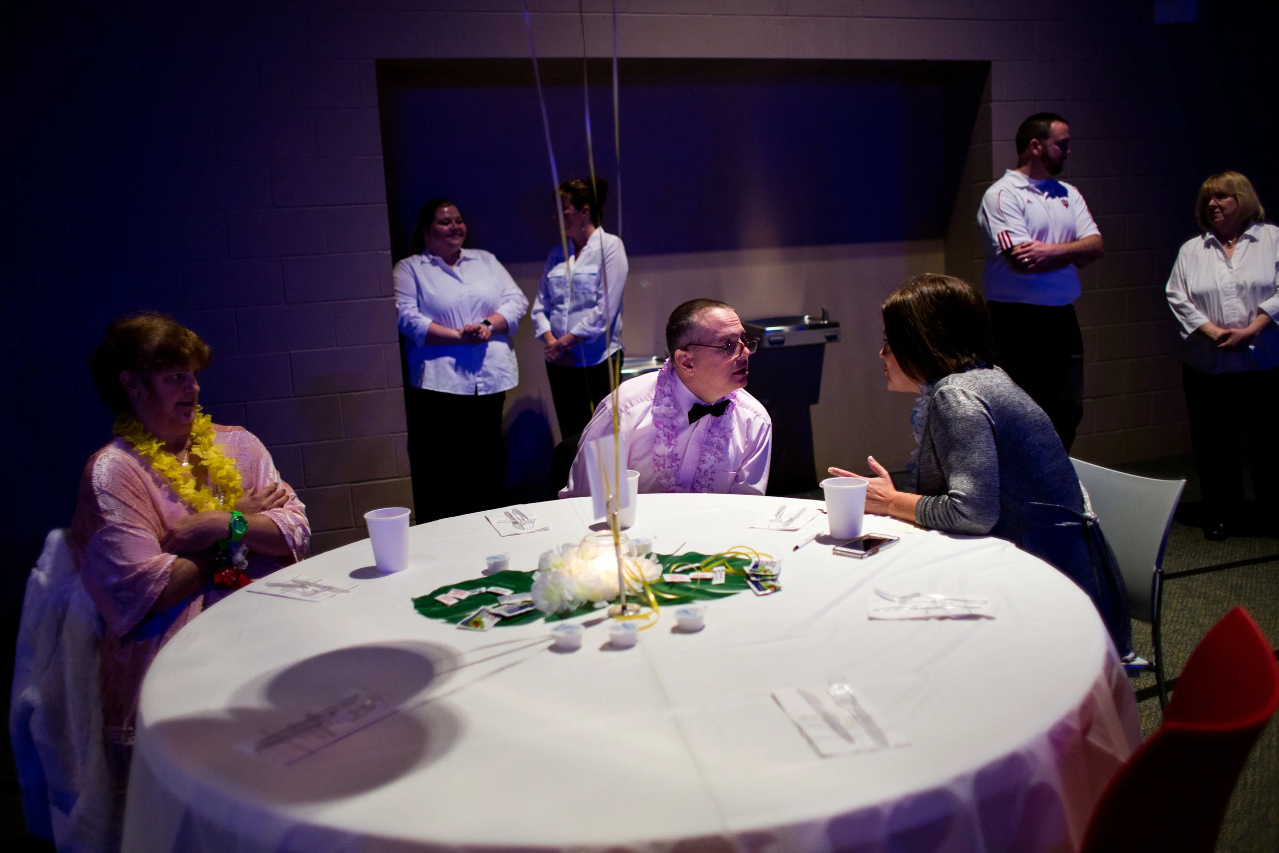 Tommy Stromire leaned over to talk to Shannon Wood while Jane Meyer, all of Jasper, listened during Friday night's Night to Shine event at Redemption Christian Church in Jasper. 