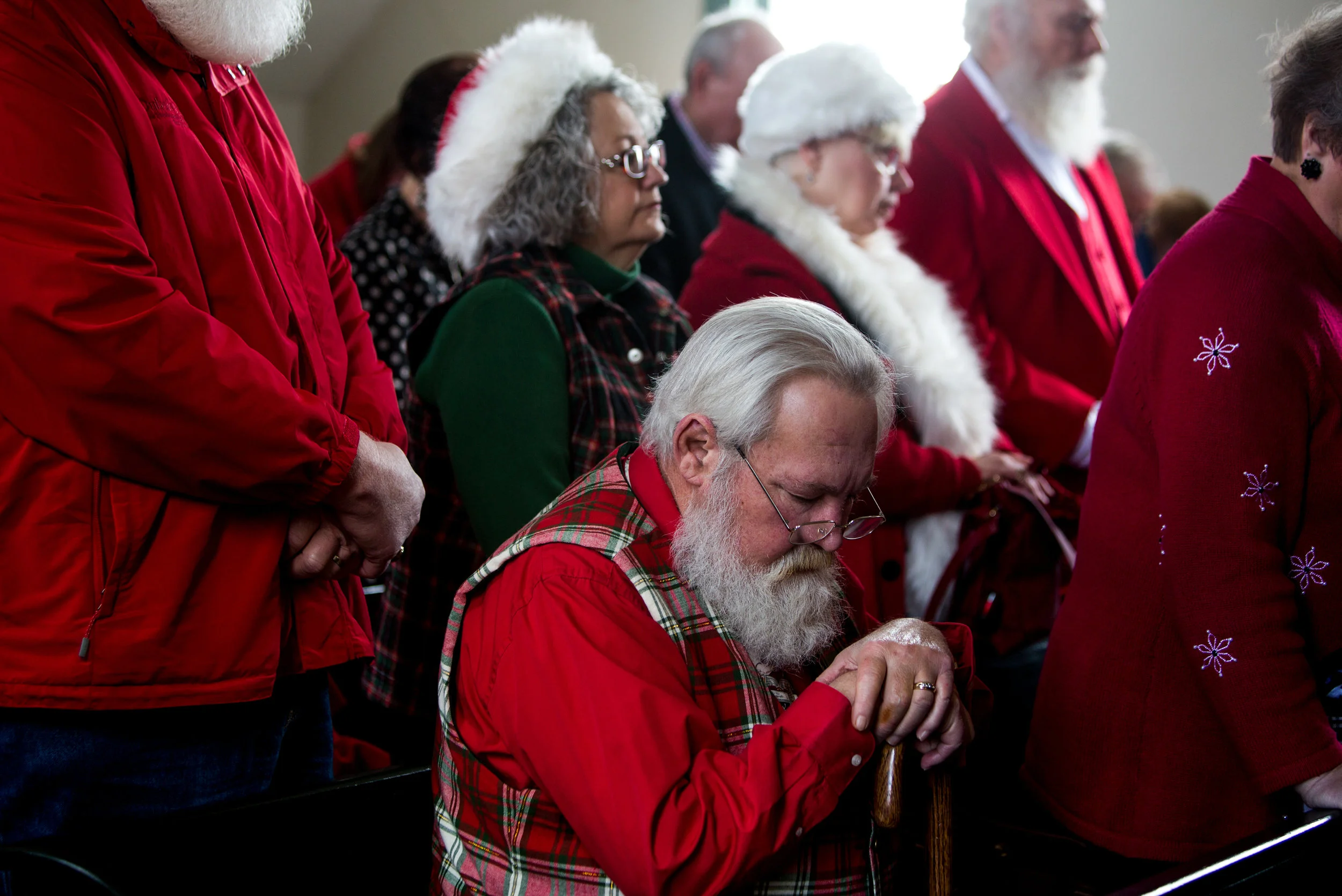 Rich Clarner of Evansville bowed his head while Rev. John Brosmer gave a closing benediction during the presentation of the Sagamore of the Wabash award to Pat Koch on behalf of her late father Raymond Joseph “Jim” Yellig on Saturday in Santa Claus. Yellig was honored for his service as Santa Claus for responding to children’s letters, spreading Christmas joy and preserving the faith of children.