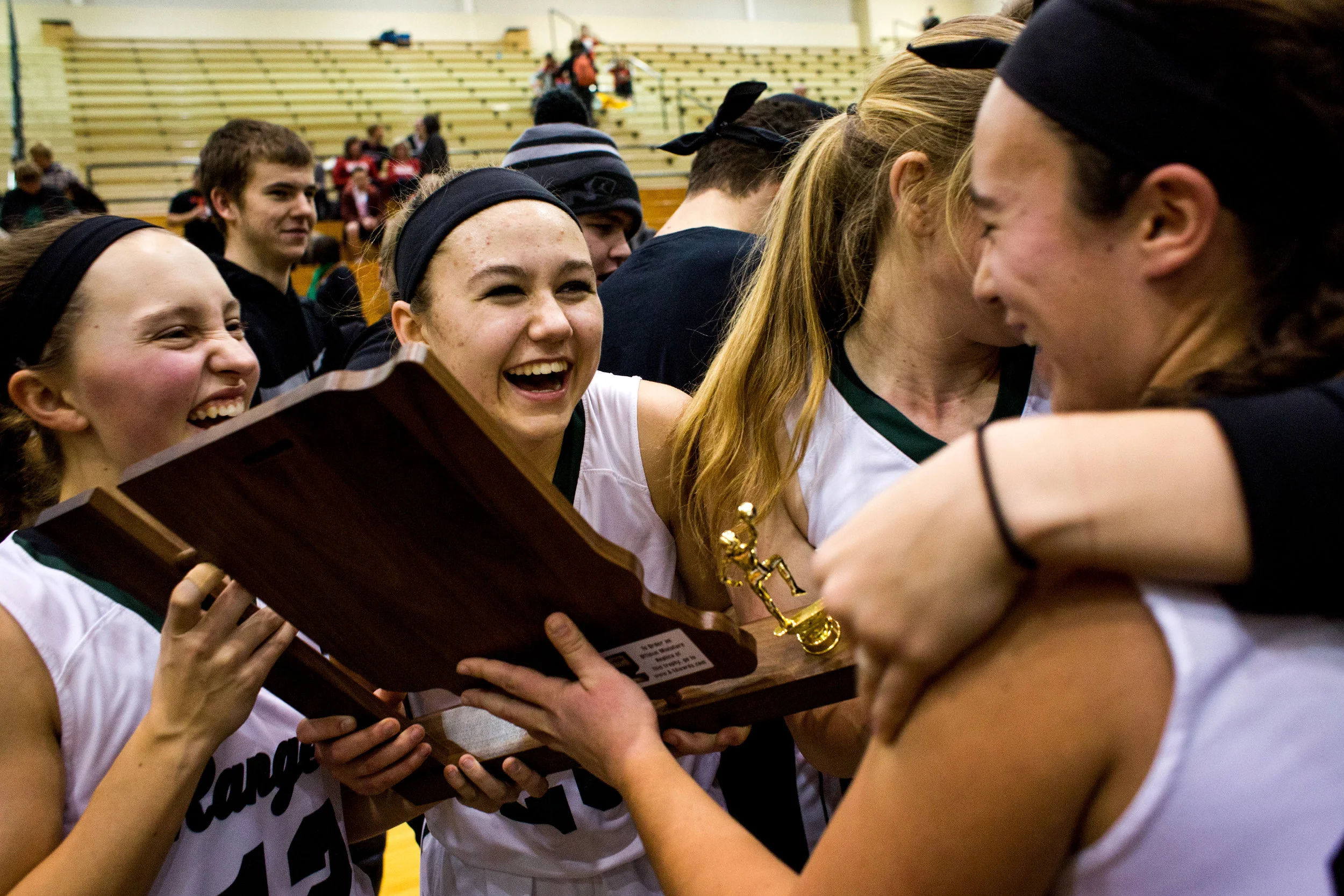 Forest Park's Samantha Jarboe, Lanette Blume, Erika Uebelhor and Emma Mehling celebrated after receiving the trophy from Saturday night's Class 2A girls sectional championship in Ferdinand. Forest Park defeated Tell City 45-35 in overtime and will advance to next week's regional championship in Paoli. 