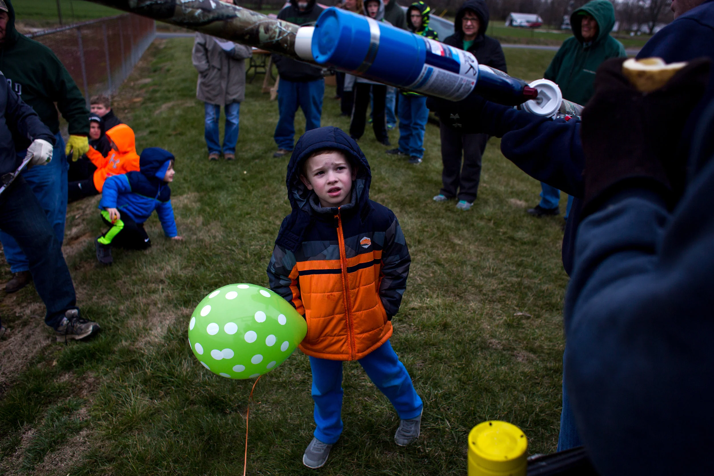 Carter Himsel of Jasper, 5, watched as his father, Jace, prepared to shoot a spud cannon outside Ireland Elementary School during Ireland's annual St. Patrick's celebration on Saturday.