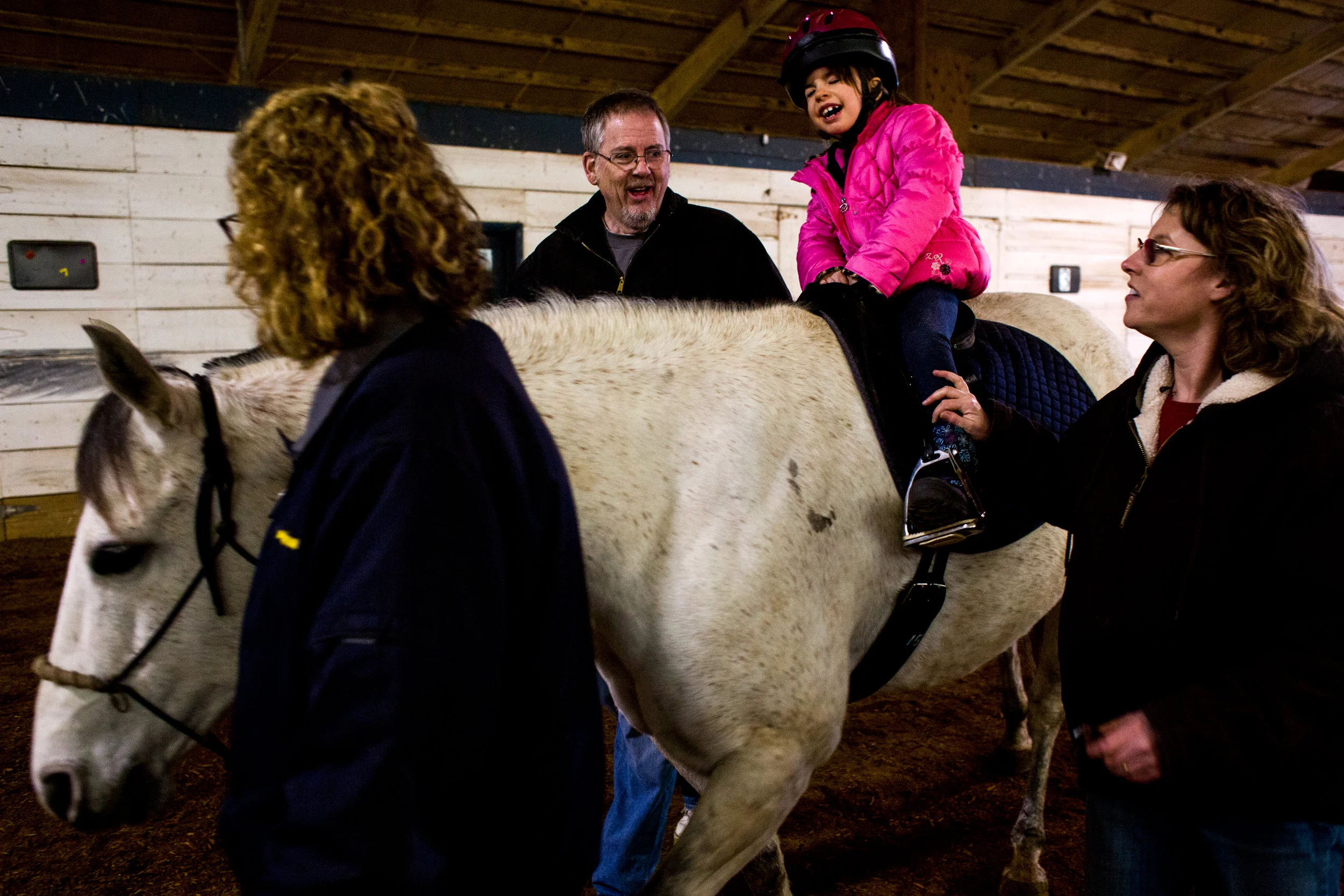 Charlotte Bradley of Ferdinand, 6, closed her eyes and counted to 10 before looking for a miniature horse figure that Hippotherapist Carrie Smith, right, had hidden in the barn during her hippotherapy lesson Thursday at Freedom Reins Therapeutic Riding Center in Jasper. Bradley has a genetic disorder called Prader-Willi syndrome, which includes symptoms like weak muscles and delayed development. Bradley began sessions with Smith last year as a way to improve coordination, balance and strength.