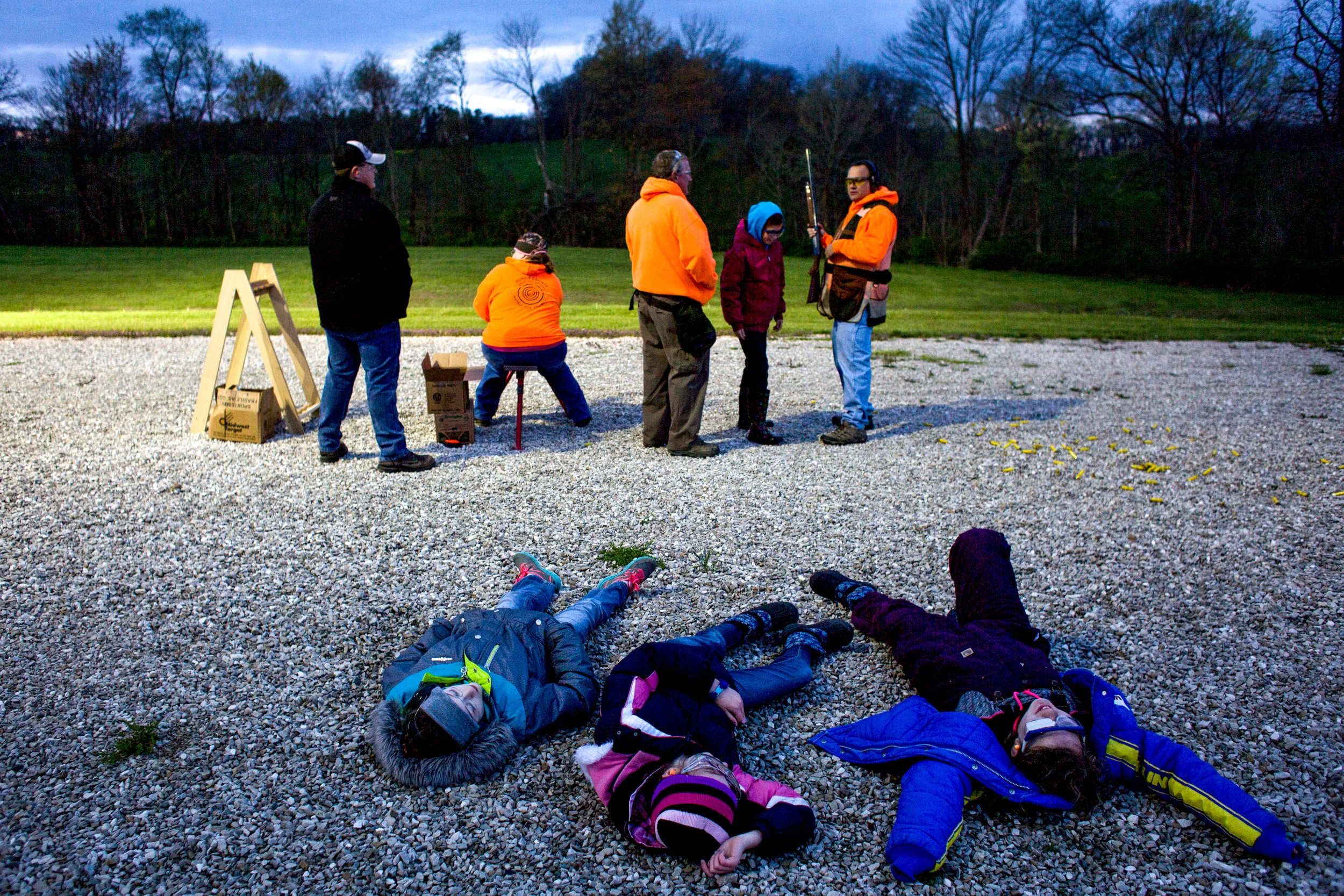 Ten-year-olds Lilly Knight of Jasper, left, Lillian Kuebler of Birdseye and Lydia Devillez of St. Anthony laid on the ground while Madelyn Miller of Birdseye practiced firing a shotgun during a Dubois County 4-H Shooting Sports meeting Thursday at the 4-H fairgrounds in Bretzville.