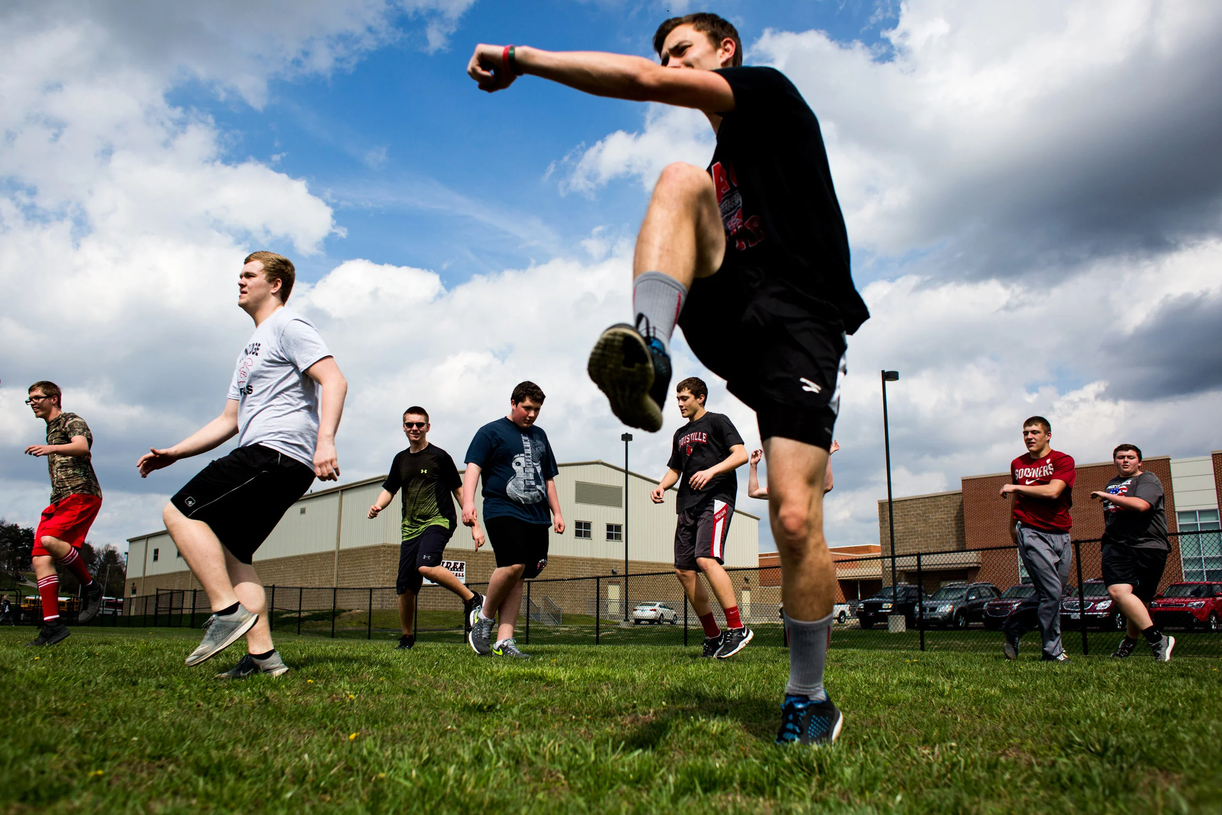 Coaches hope the newly-formed Unified Track team at Southridge High School will support inclusiveness and community at the school. Sophomore Corbin Neher, center, led the school's the team in stretches during Tuesday’s practice. The Unified Track team allows students with special needs to be assisted by student athletes twice a week in their training and while competing in events.