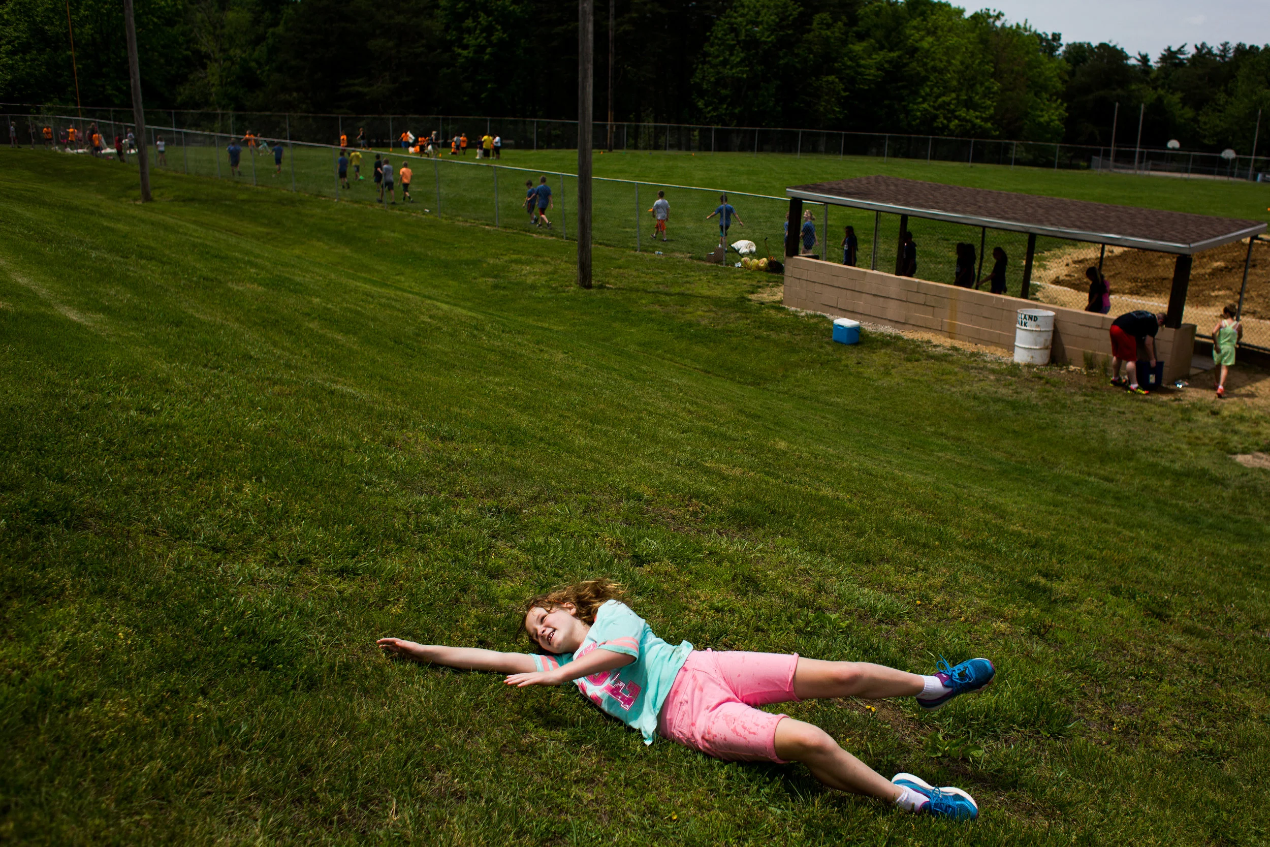 Holland Elementary School fourth-grader Jill Keusch rolled down the hill during the school’s field day Wednesday at Holland Park.